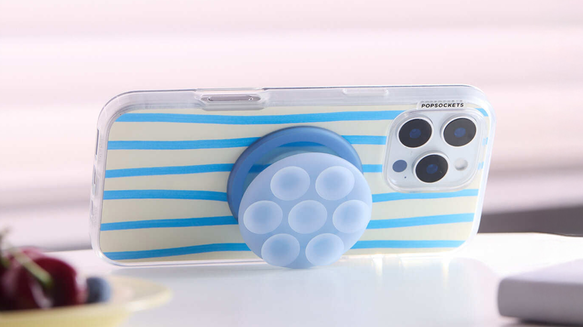 A phone with a Suck Up Popsocket grip on it.