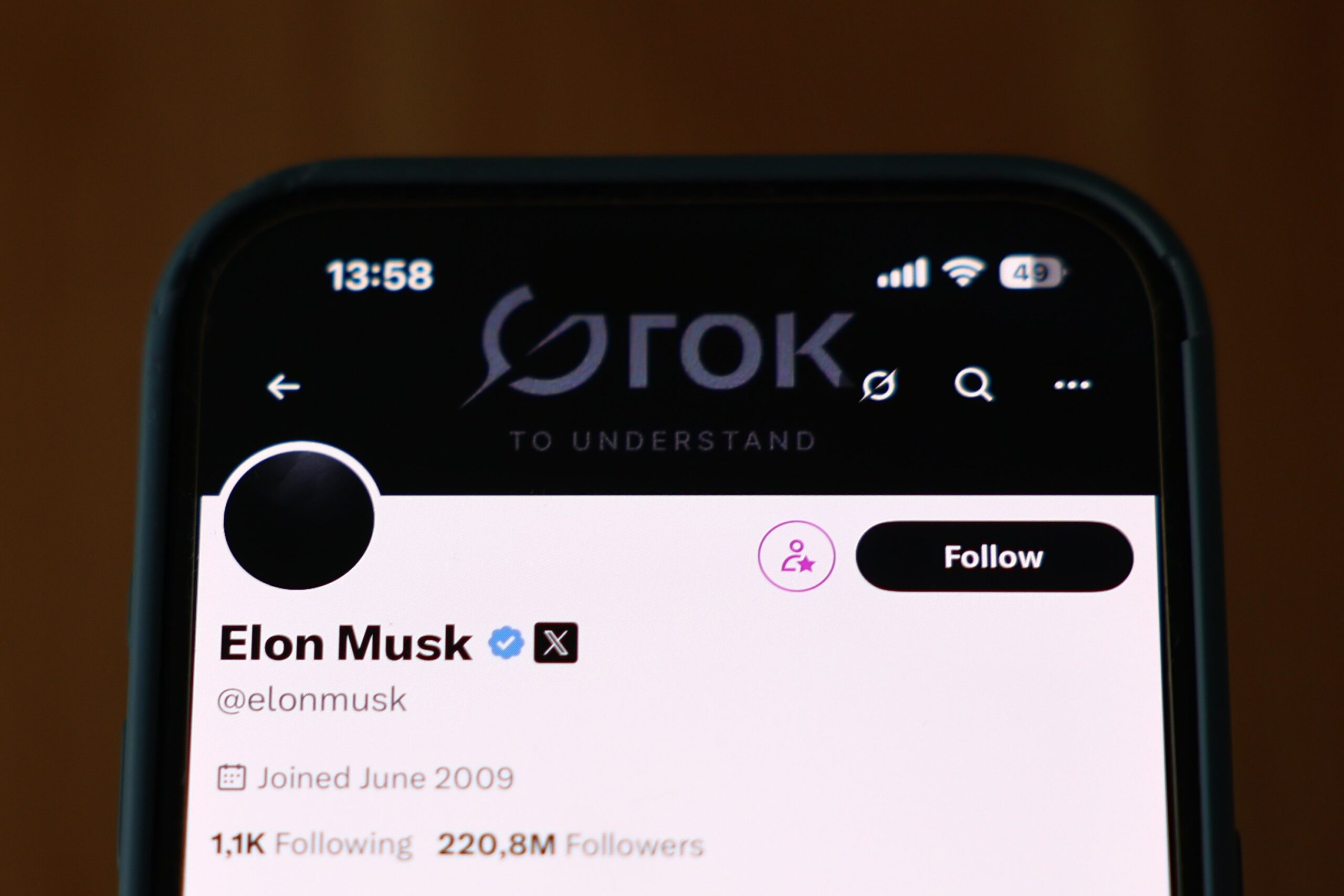 A phone screen showing Elon Musk's X profile. 