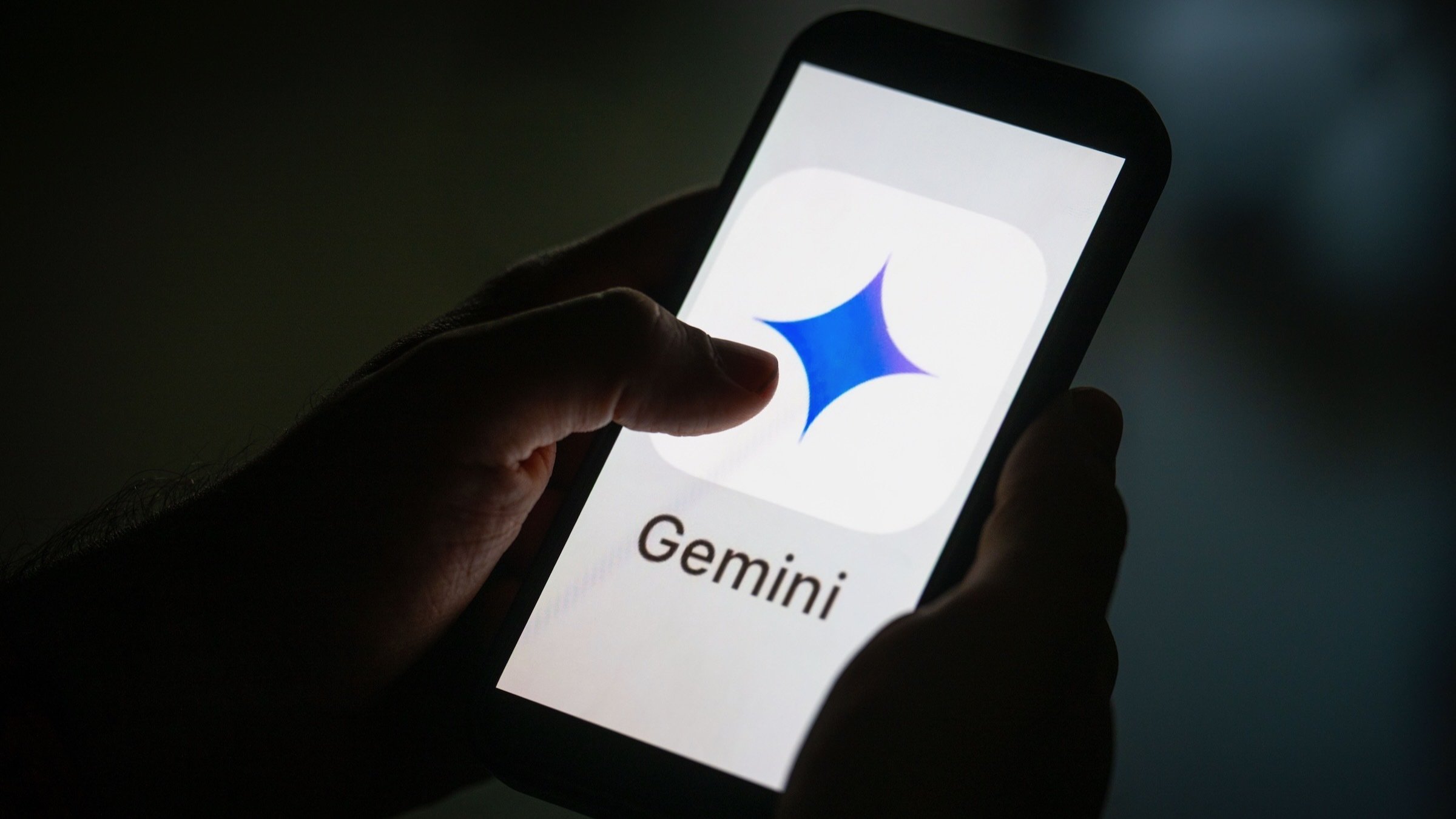 illustration of Google Gemini logo is seen on a mobile screen