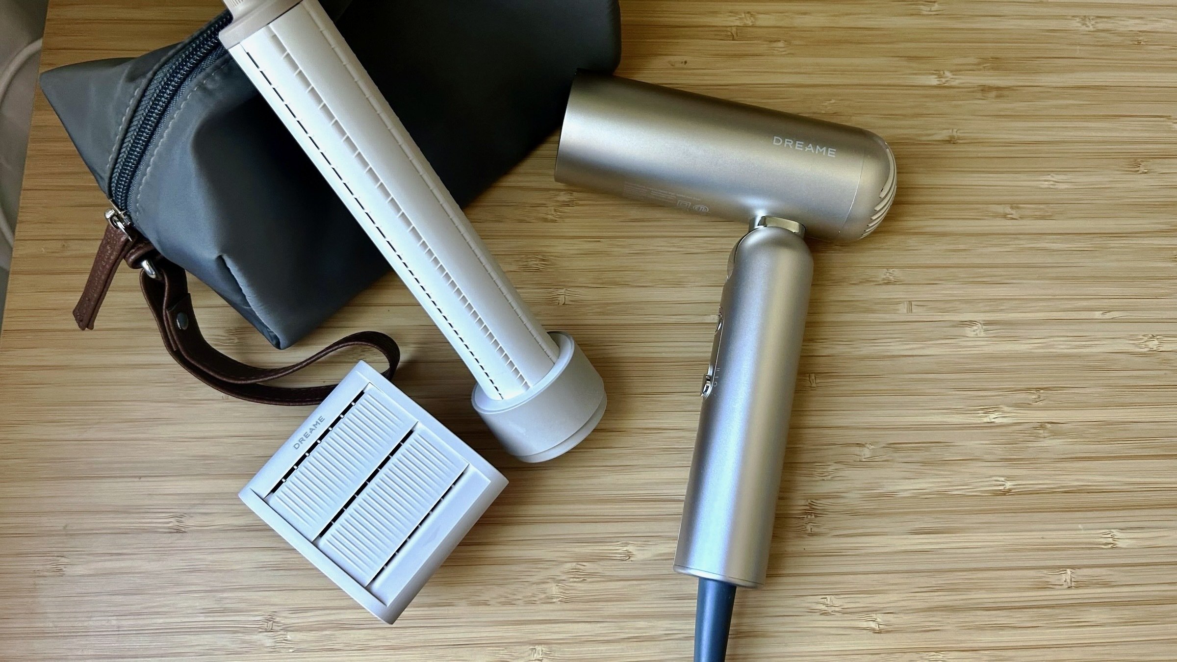 the Dreame pocket hair dryer with its accessories on a tabletop