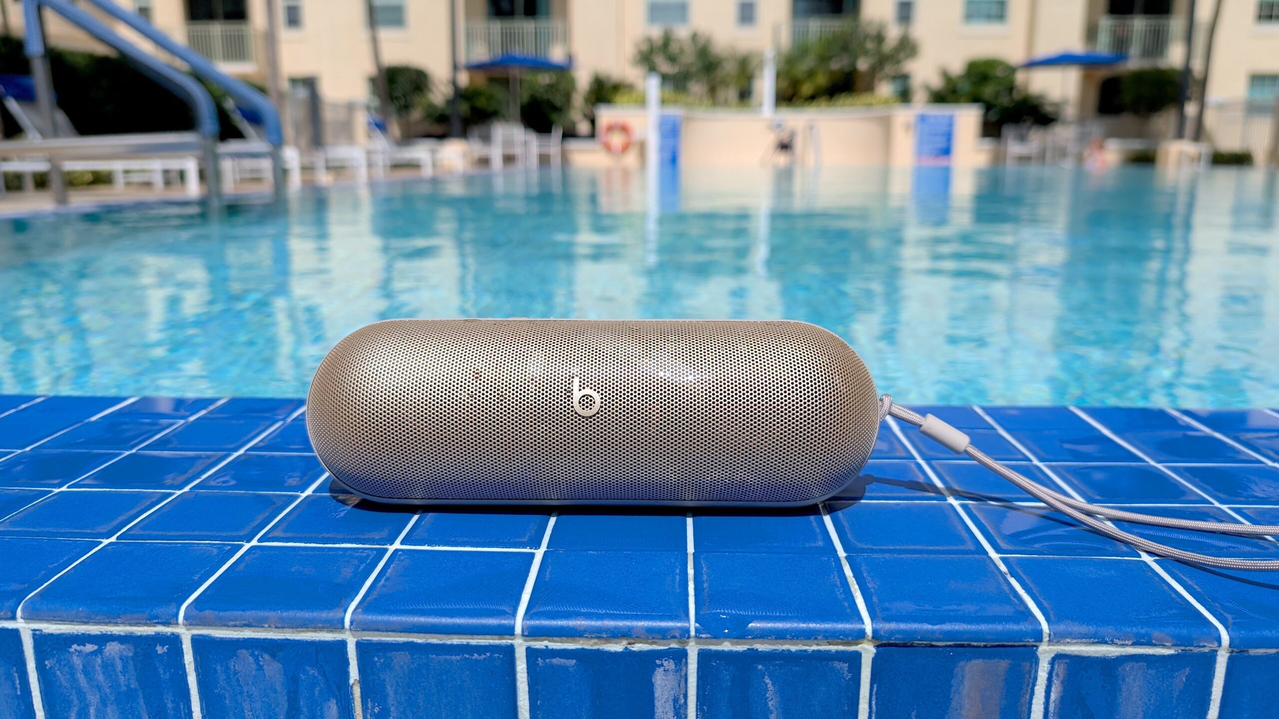 beats pill speaker resting at edge of a pool