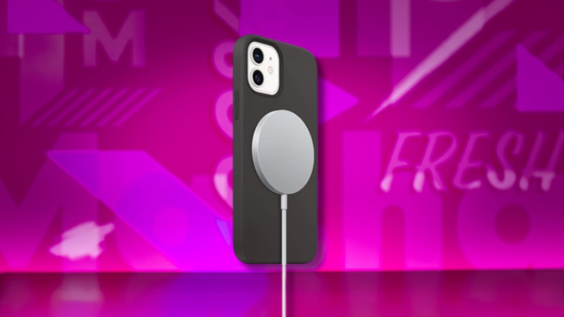 apple magsafe wireless charger on a phone against a pink patterned background