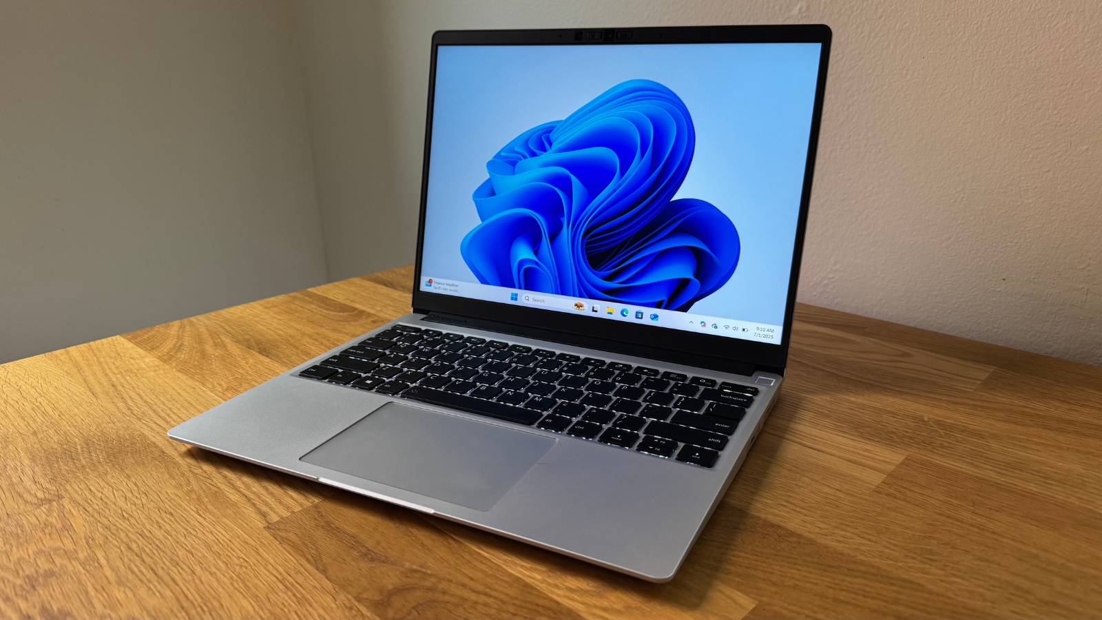 a framework laptop 13 on a wooden desk