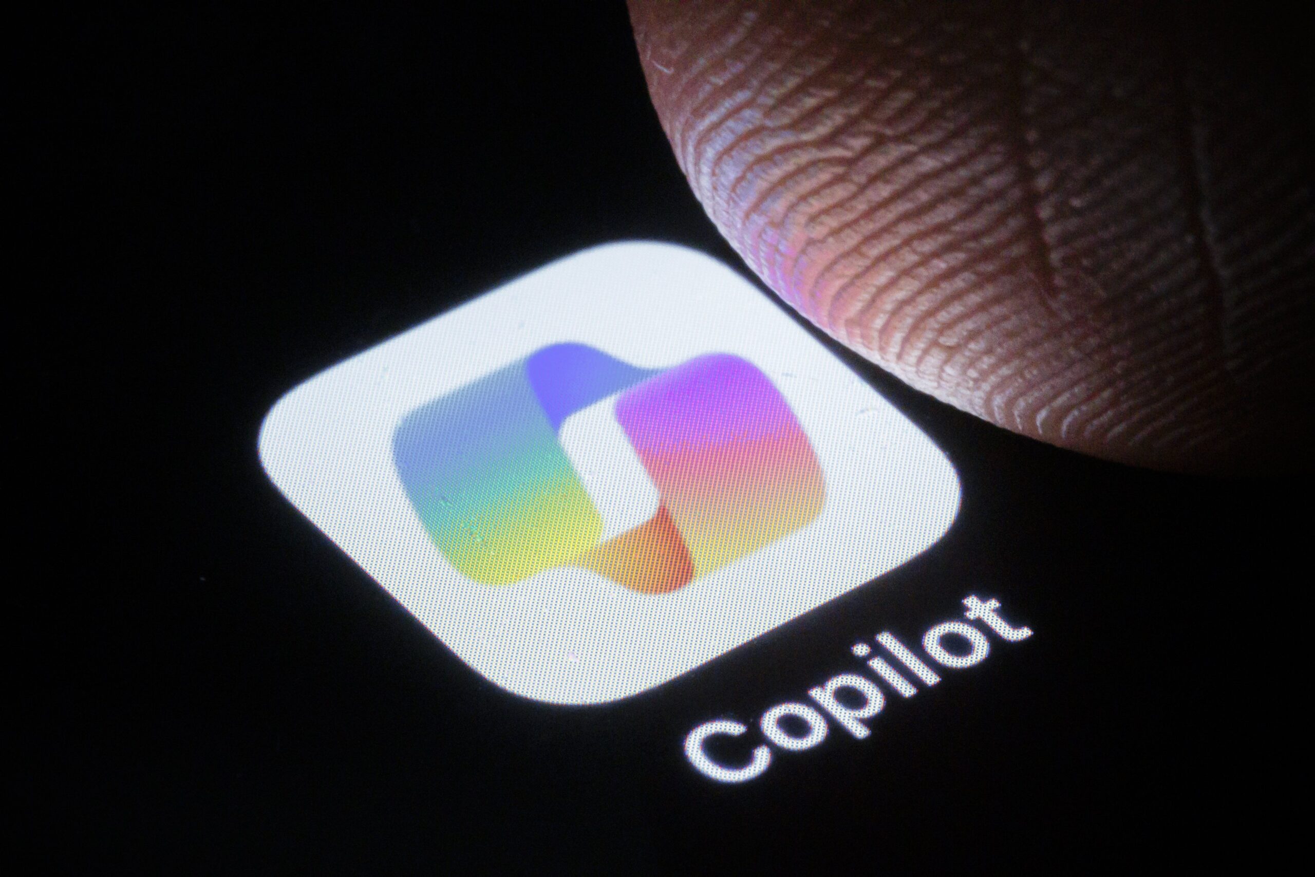 A finger taps on the CoPilot app.