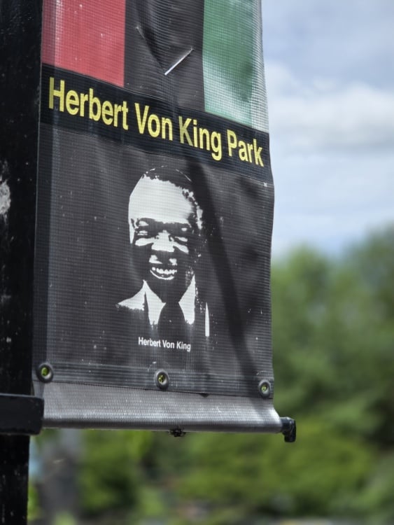 Portrait shot of a Herbert Von King banner in Brooklyn