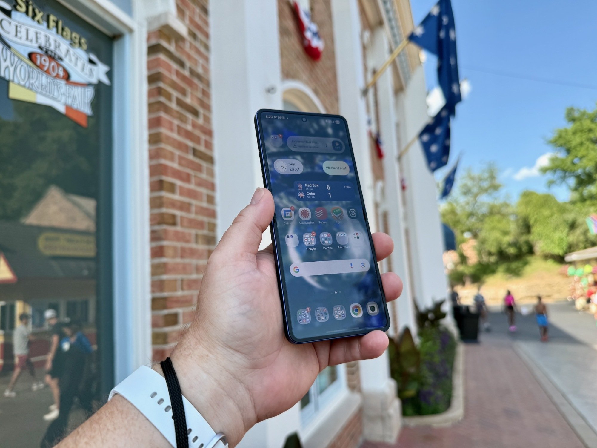 the samsung z Flip 7 in a hand at a six flags park