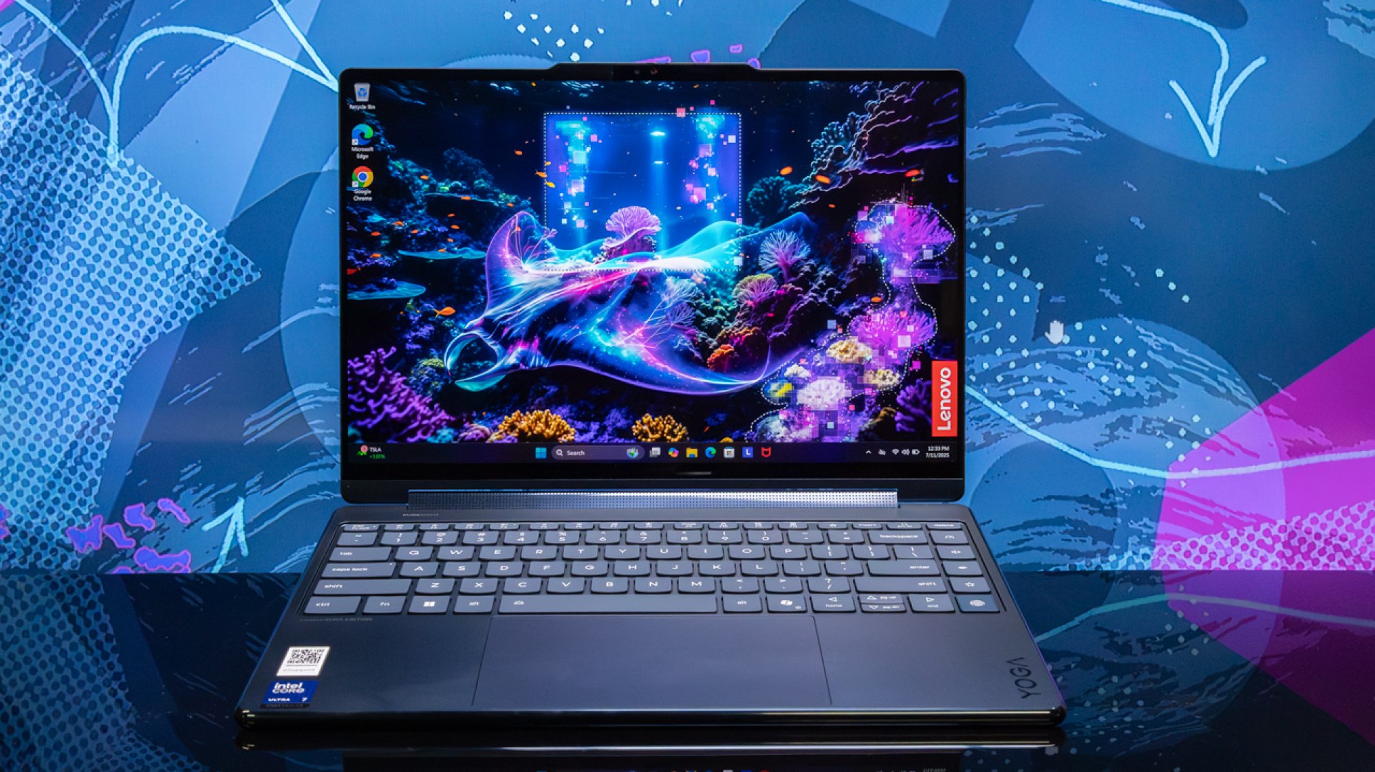 lenovo yoga 9i aura edition 2-in-1 laptop against blue and purple backdrop