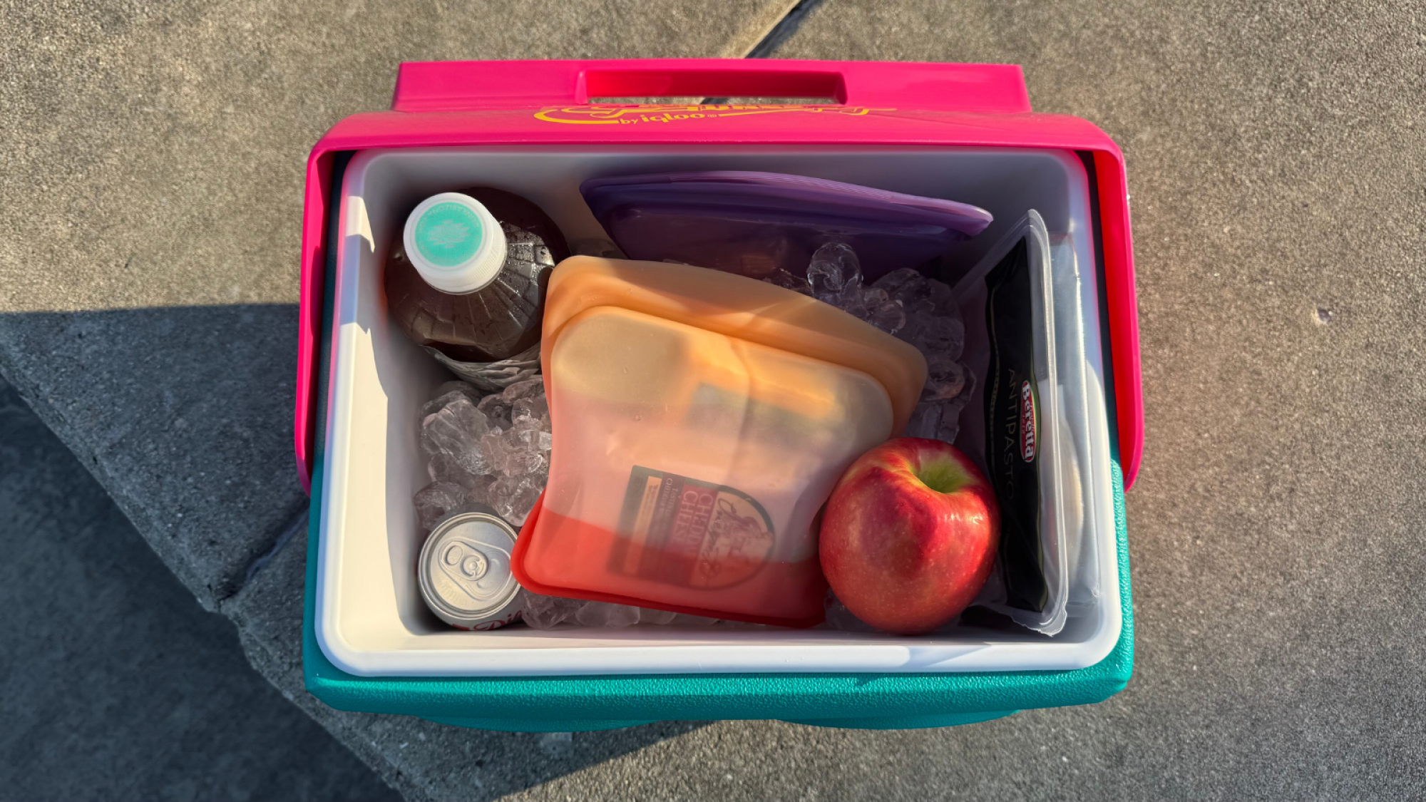 a top-down view of an igloo kooltunes filled with snacks and drinks