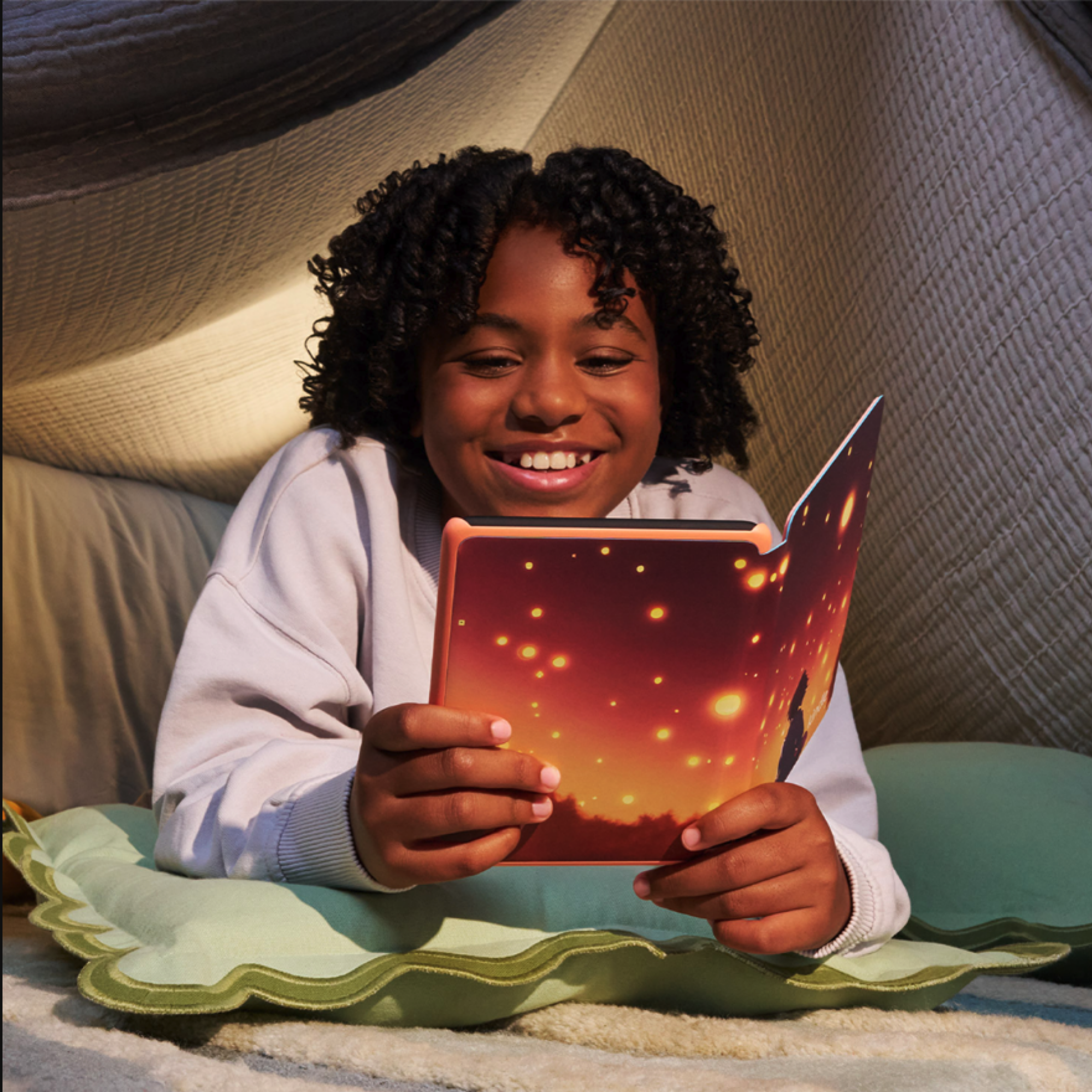 young girl reading on the Kindle Colorsoft Kids with starlight reading cover.