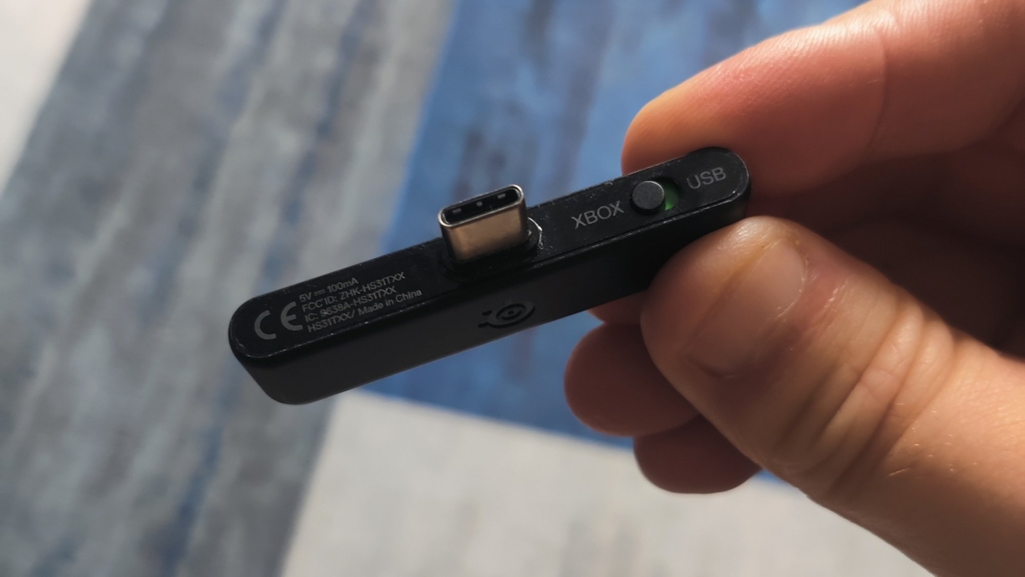 The USB-C dongle for the SteelSeries Arctis Nova 7X Wireless gaming headset in 'Xbox' mode