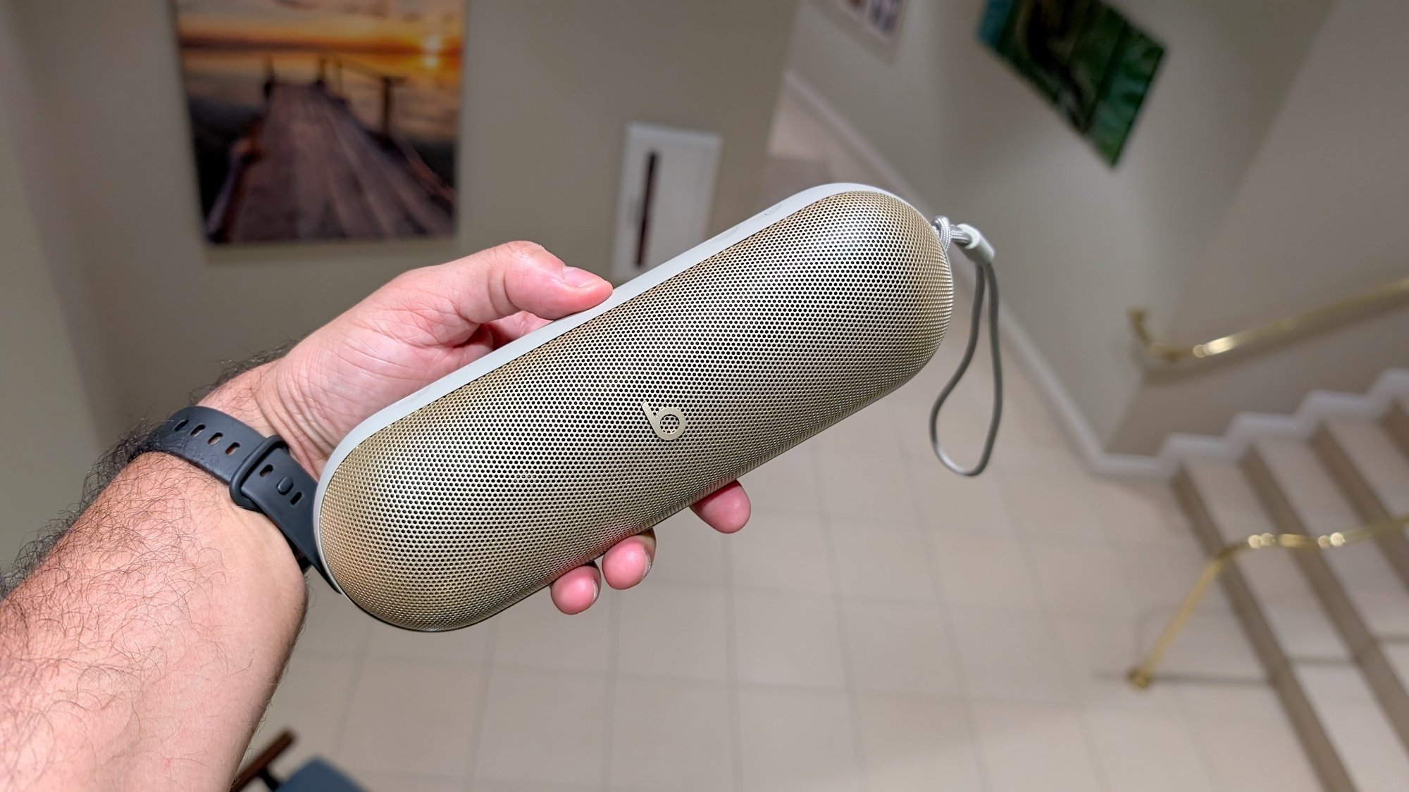 man holding beats pill portable speaker