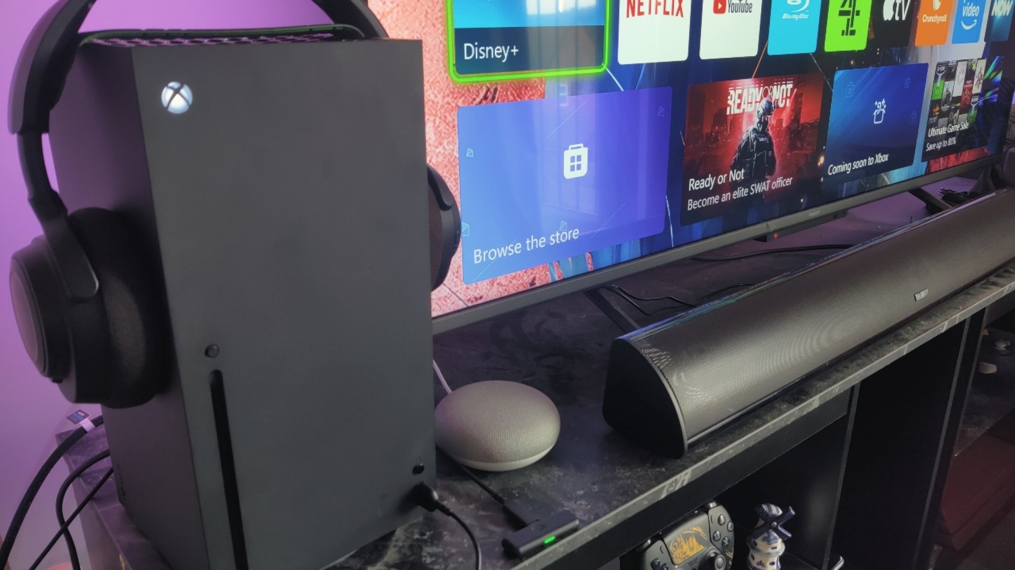 The SteelSeries Arctis Nova 7X connected to an Xbox Series X connected via dongle and the USB adapter
