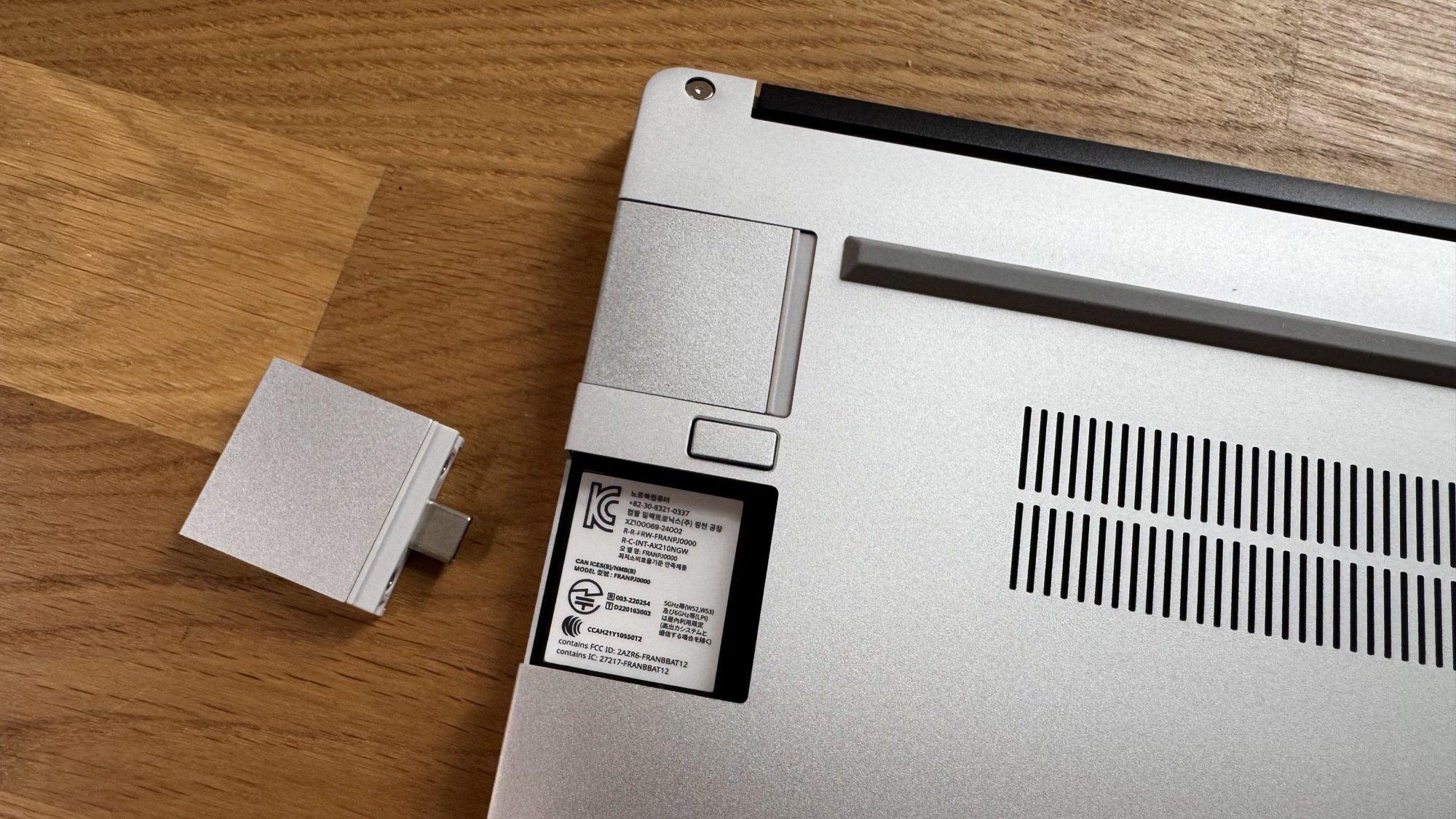 an expansion port next to the underside of a framework laptop 13