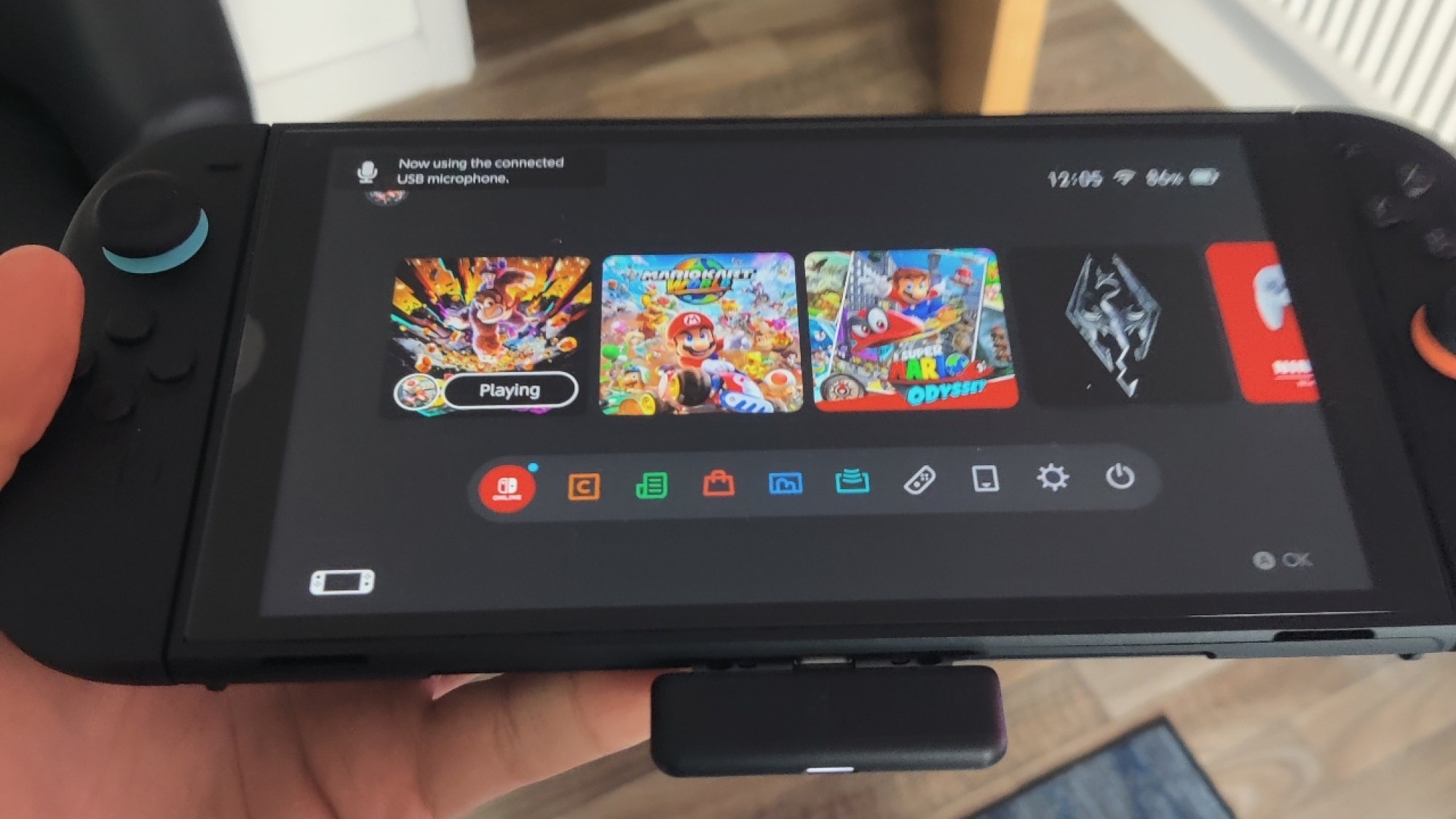 The SteelSeries Arctis Nova 7X headset's dongle plugged into a Nintendo Switch 2