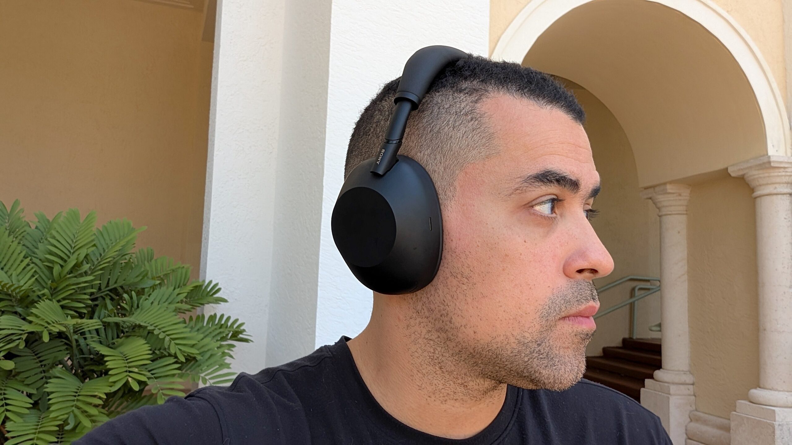 Alex Bracetti wearing his Sony headphones outdoors