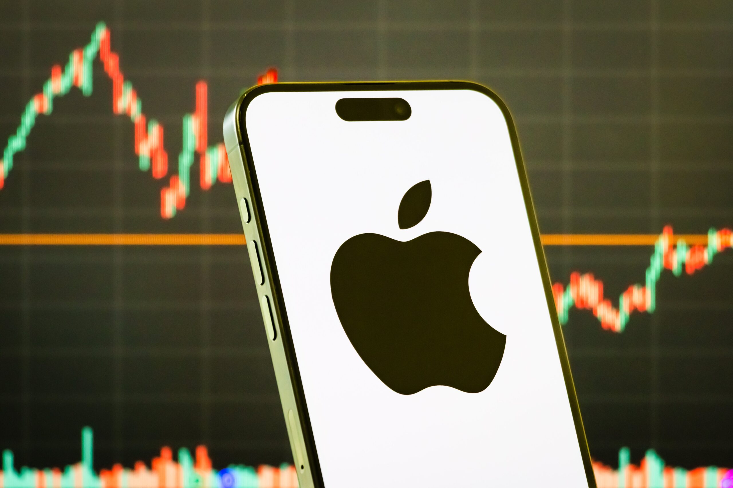 apple logo in front of a stock chart