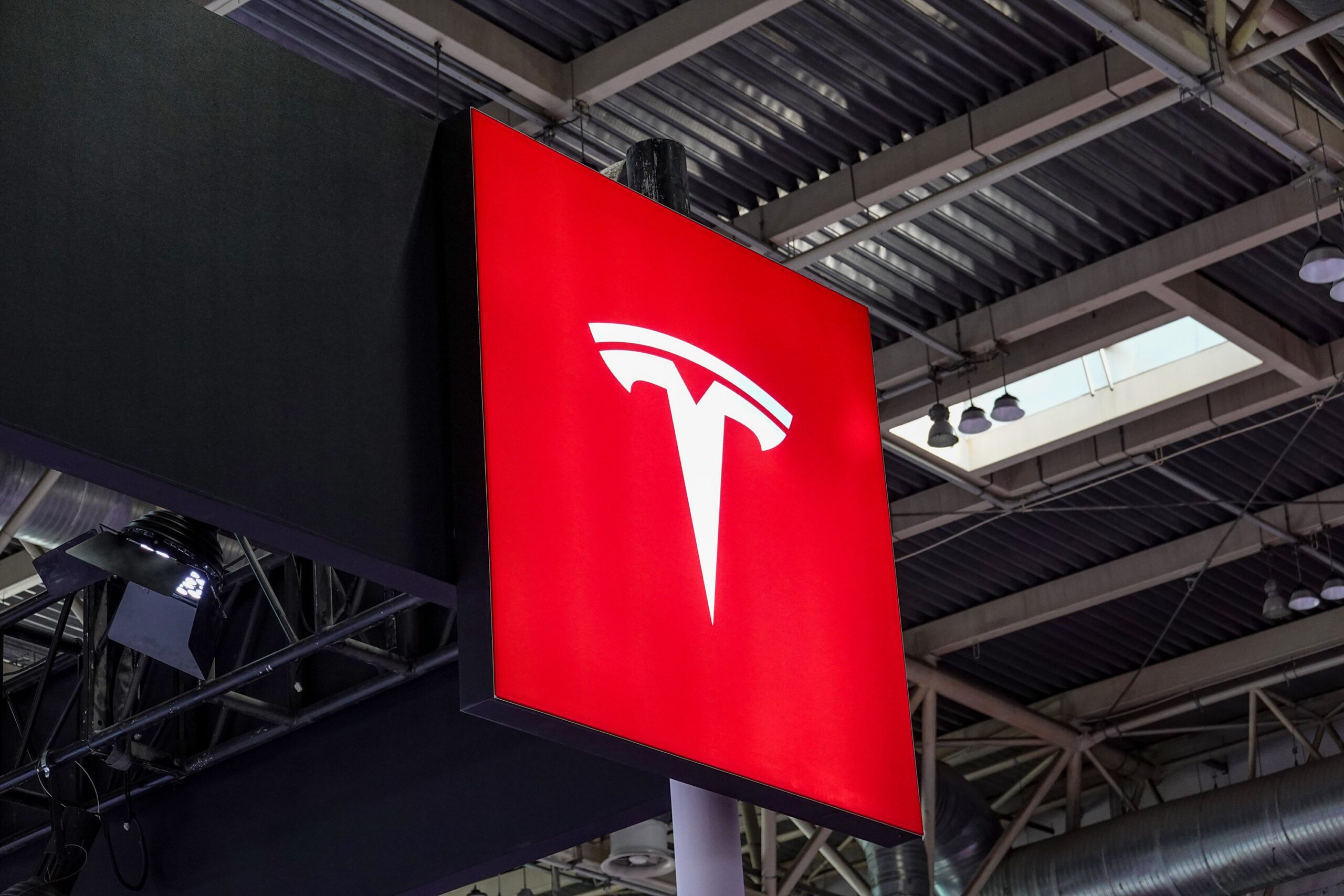 tesla logo high up in a conference room