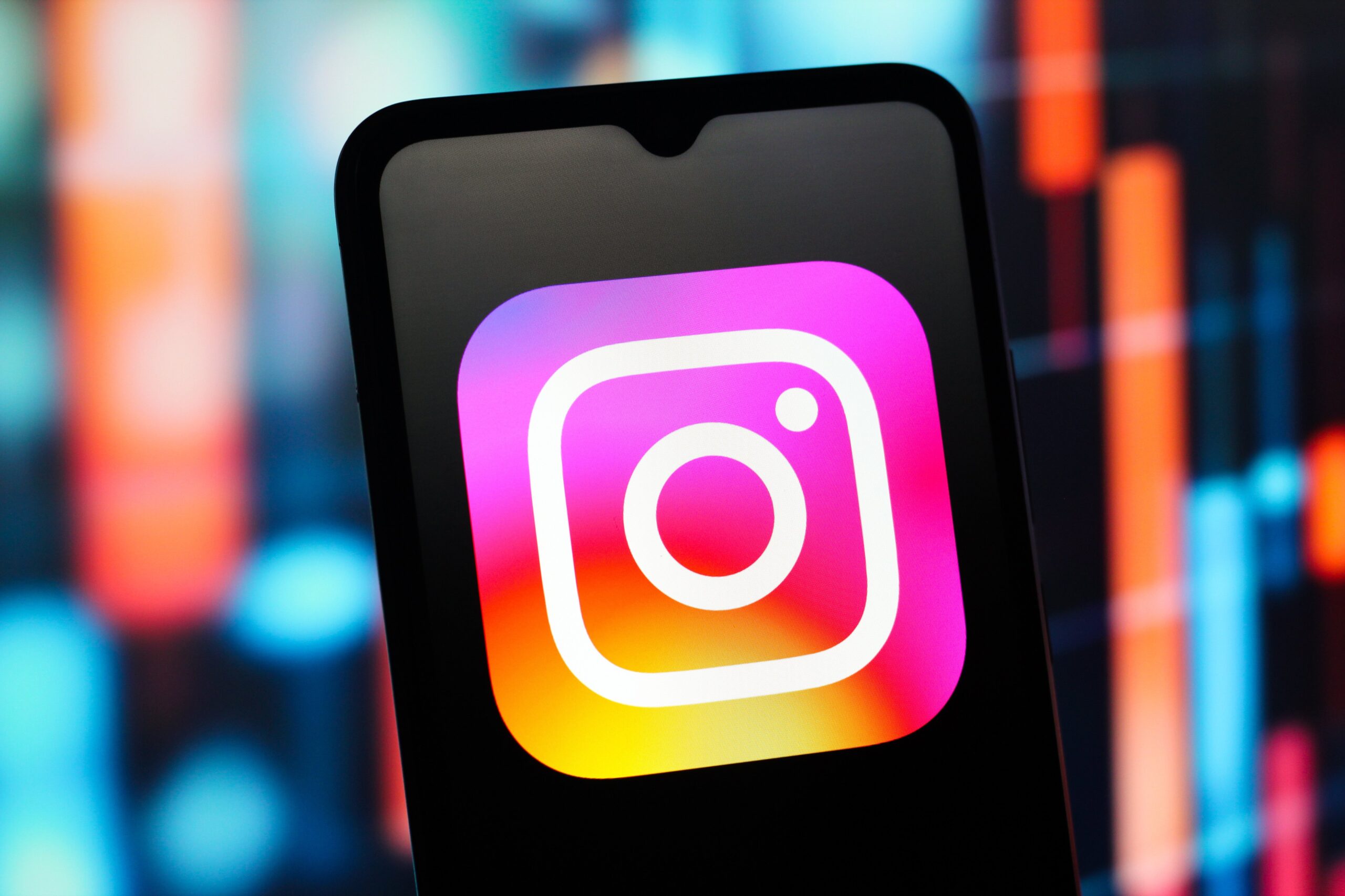 Instagram logo is seen displayed on a smartphone screen.