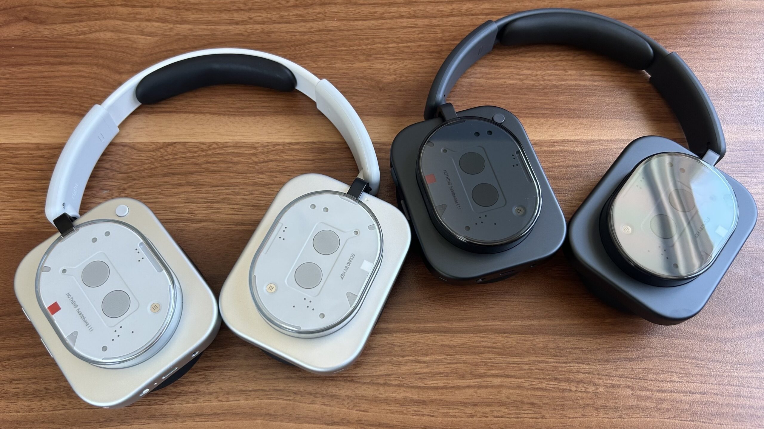 white and black nothing headphone (1) on desk