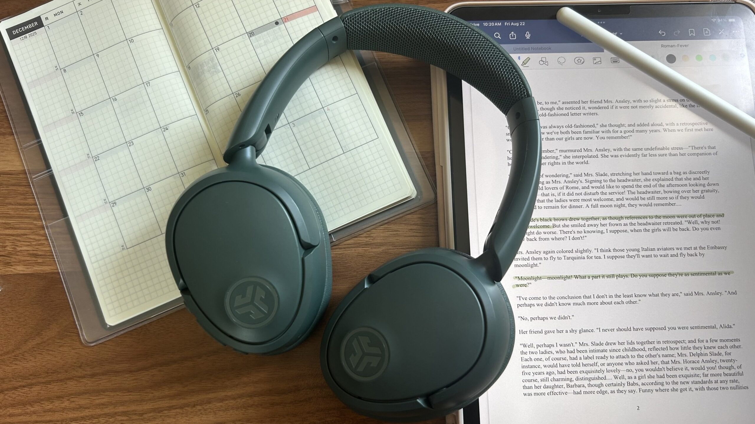 sage jlab jbuds lux headphones on top of ipad with short story open and open planner page