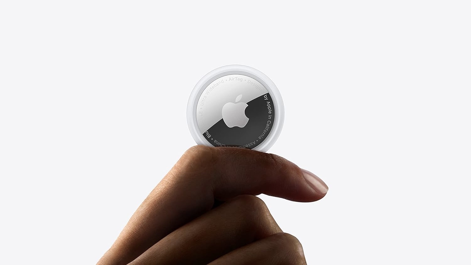 person holding apple airtag