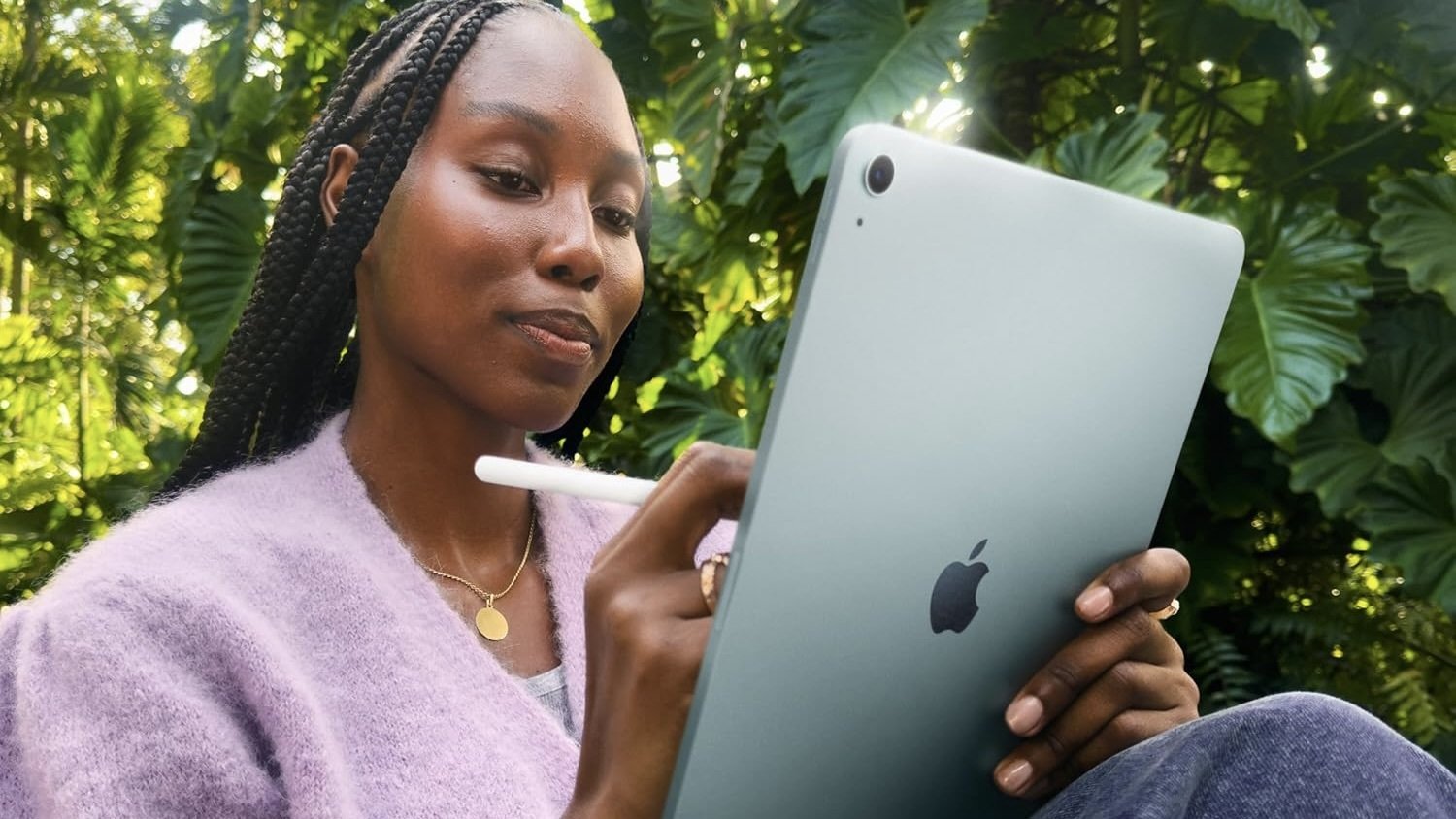 person sitting outside working on blue ipad air