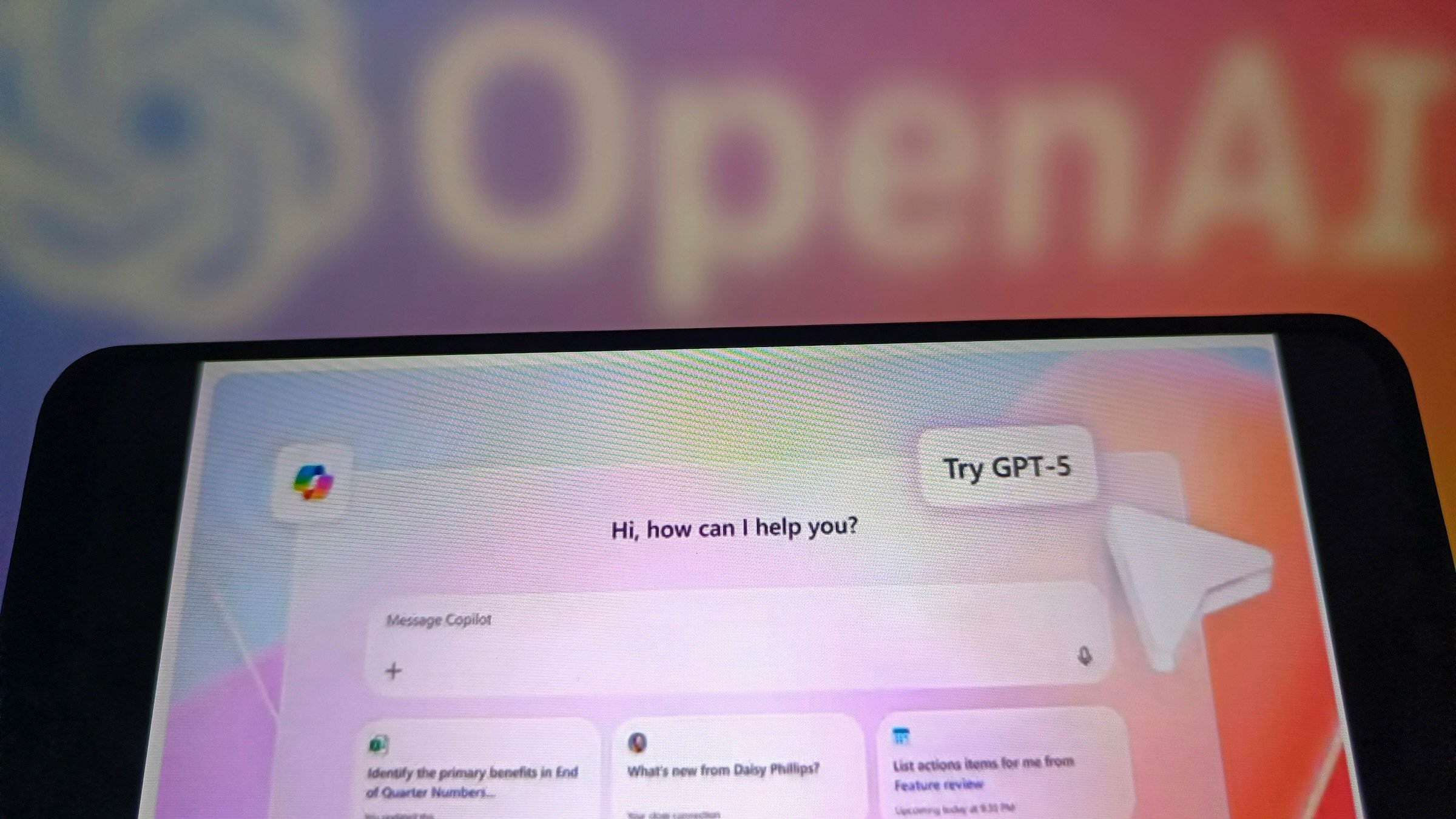 GPT-5 displayed in a smartphone with the OpenAI logo in background 