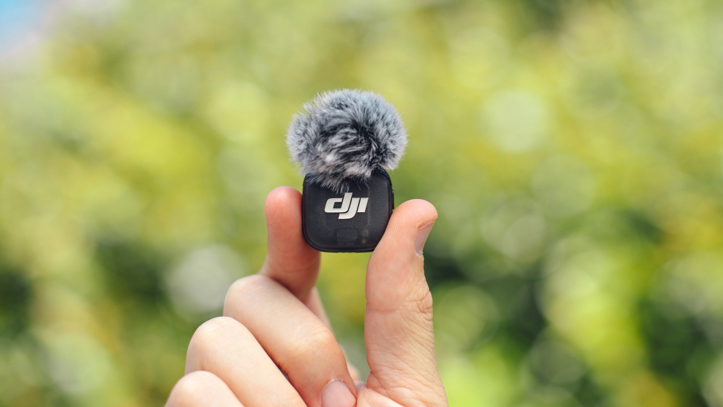 dji mic 3 with wind guard held in hand