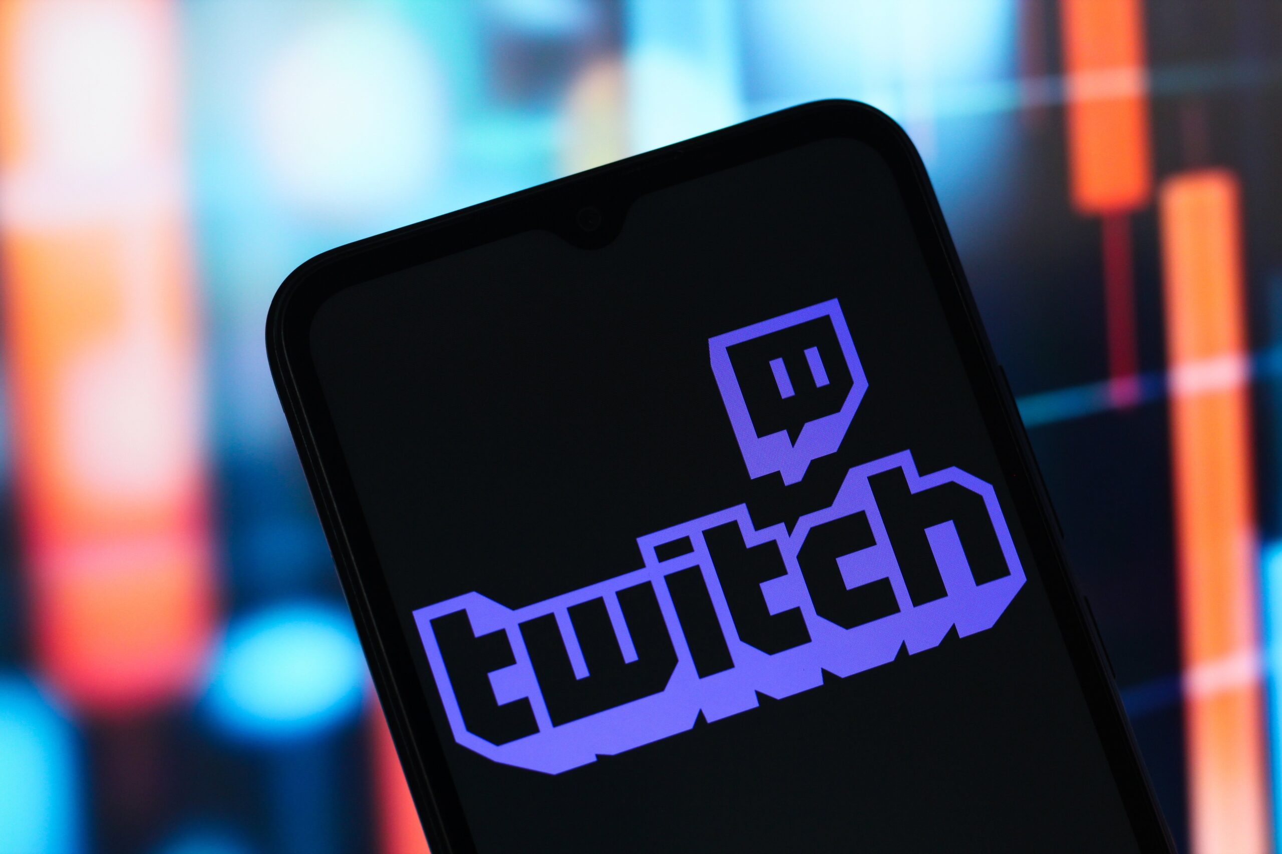 The Twitch logo is seen displayed on a smartphone screen.