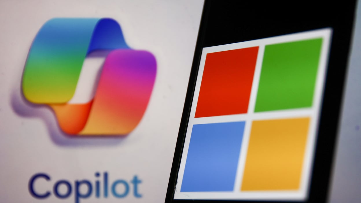 Copilot's multicolored logo in the background, with Microsoft's logo against it.