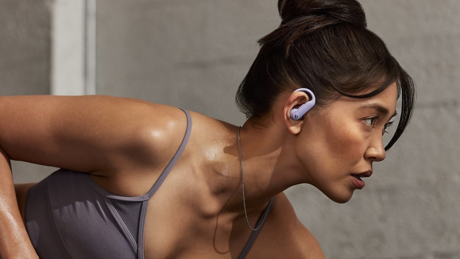 person mid workout wearing purple powerbeats pro 2