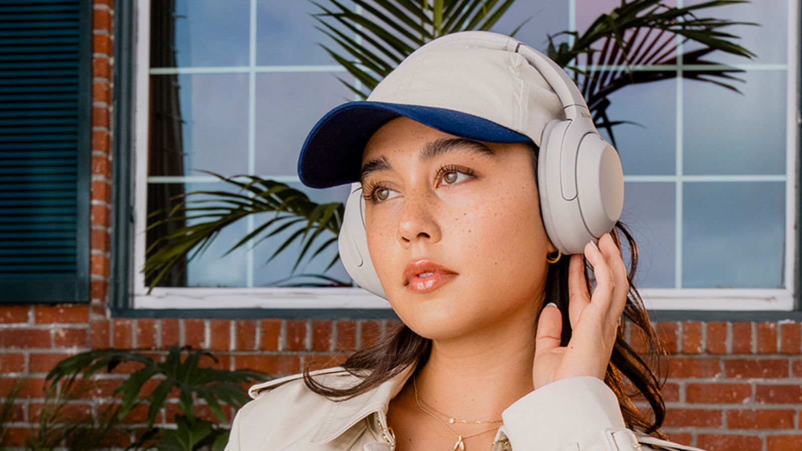 woman wearing Sony WH-1000XM4 headphones