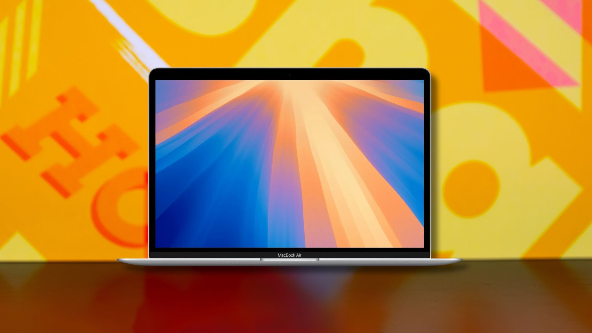 apple macbook air m1 laptop against a yellow patterned background