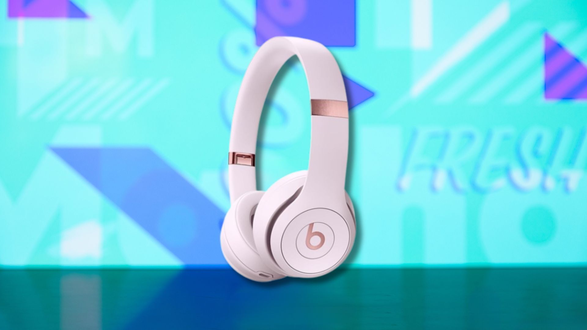 cloud pink beats solo 4 headphones against a light blue patterned background