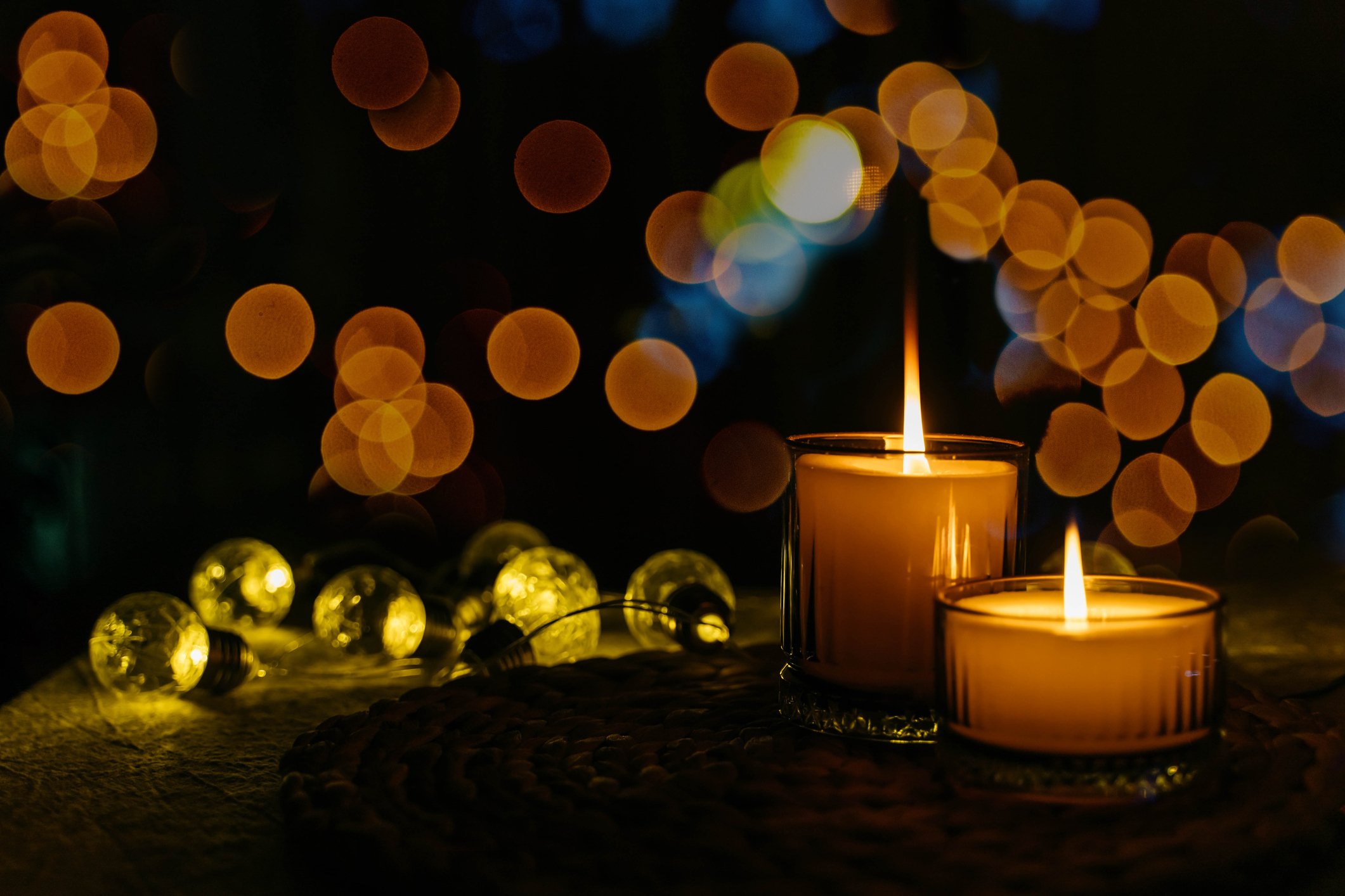 two vigil candles against a dark backdrop