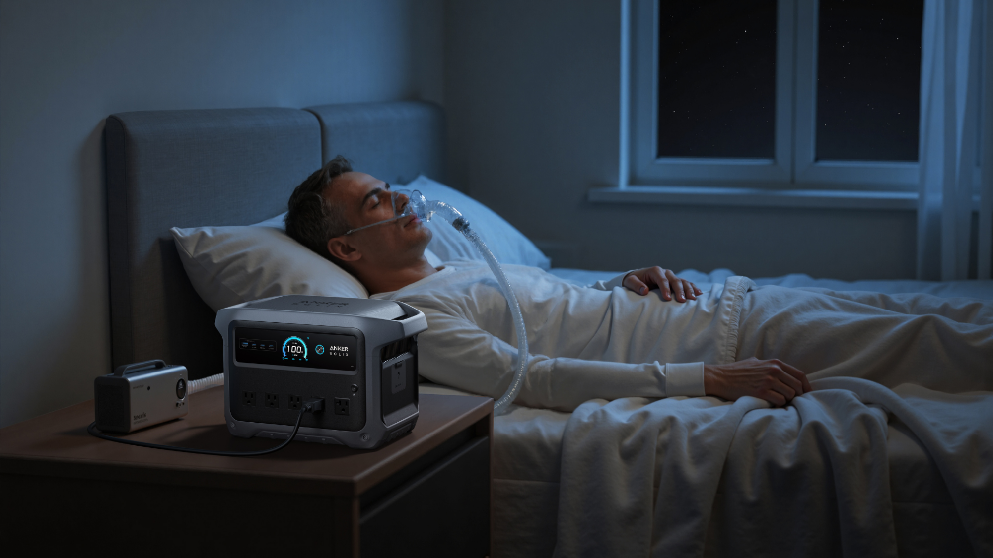 A person sleeping in a bed with a c-pap machine.
