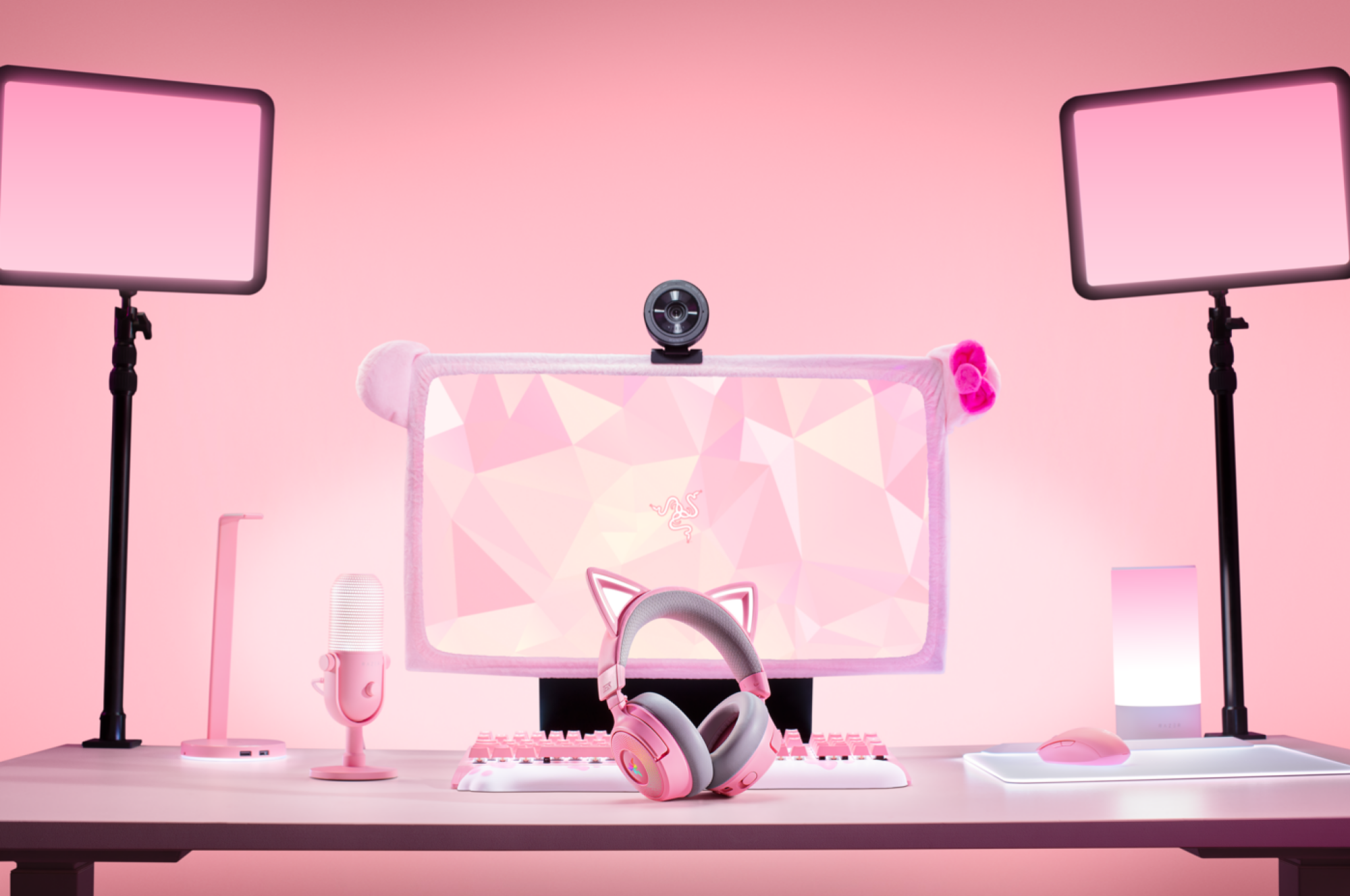 the razer kraken kitty v3 pro headset at a pink gaming station