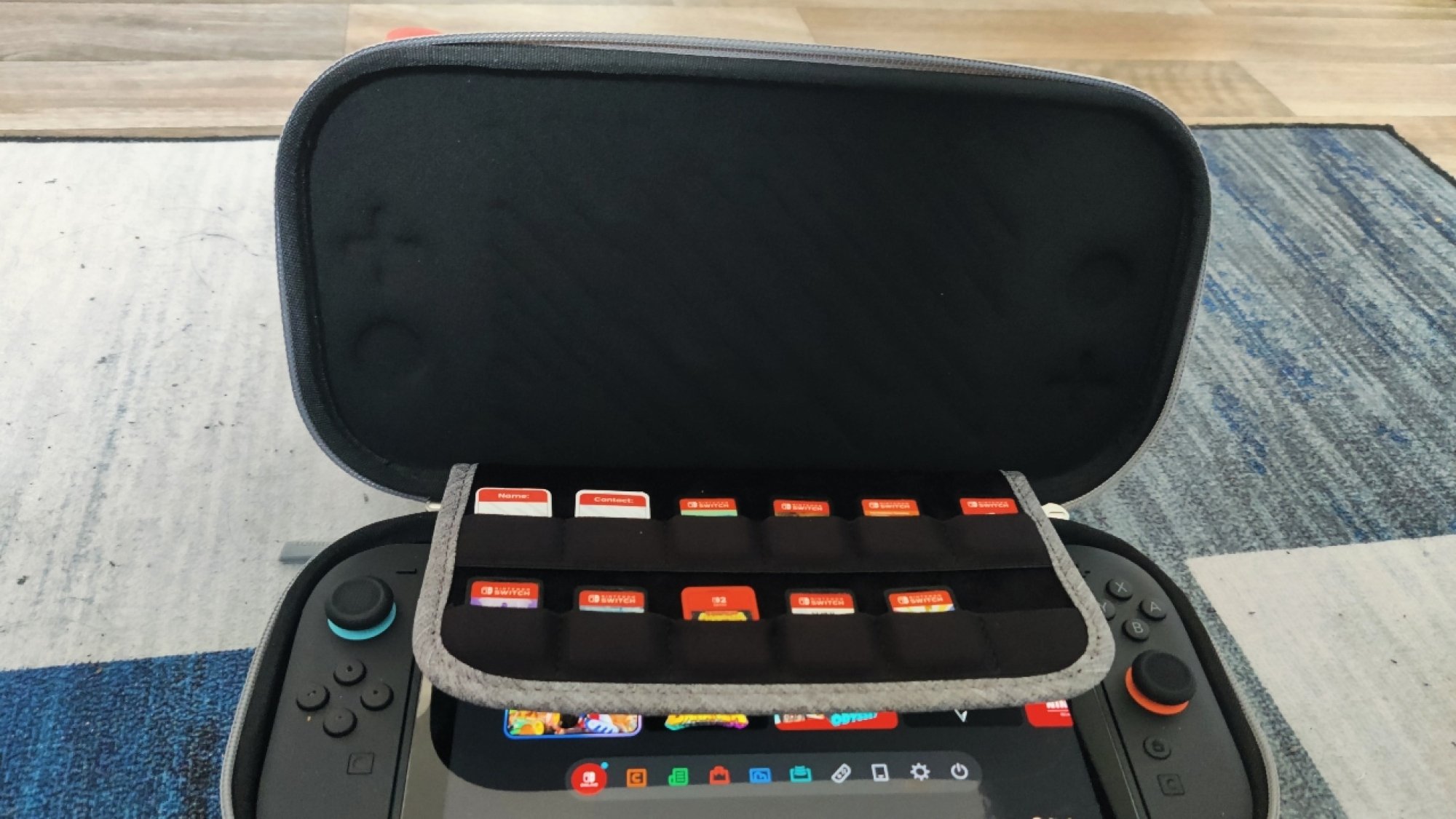 The inside of the tomtoc Switch 2 carrying case, showing the 12 game cartridge pouch