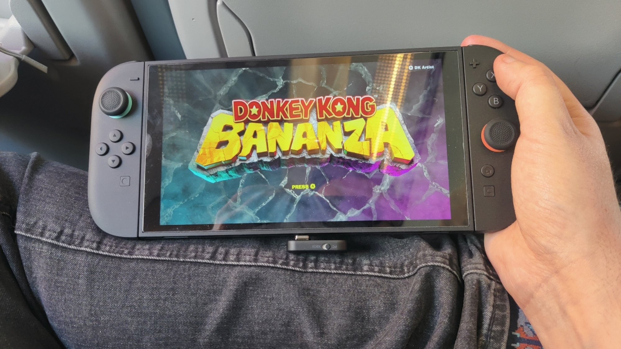 Plugging in the USB-C dongle for the SteelSeries Arctis GameBuds X into a Nintendo Switch 2