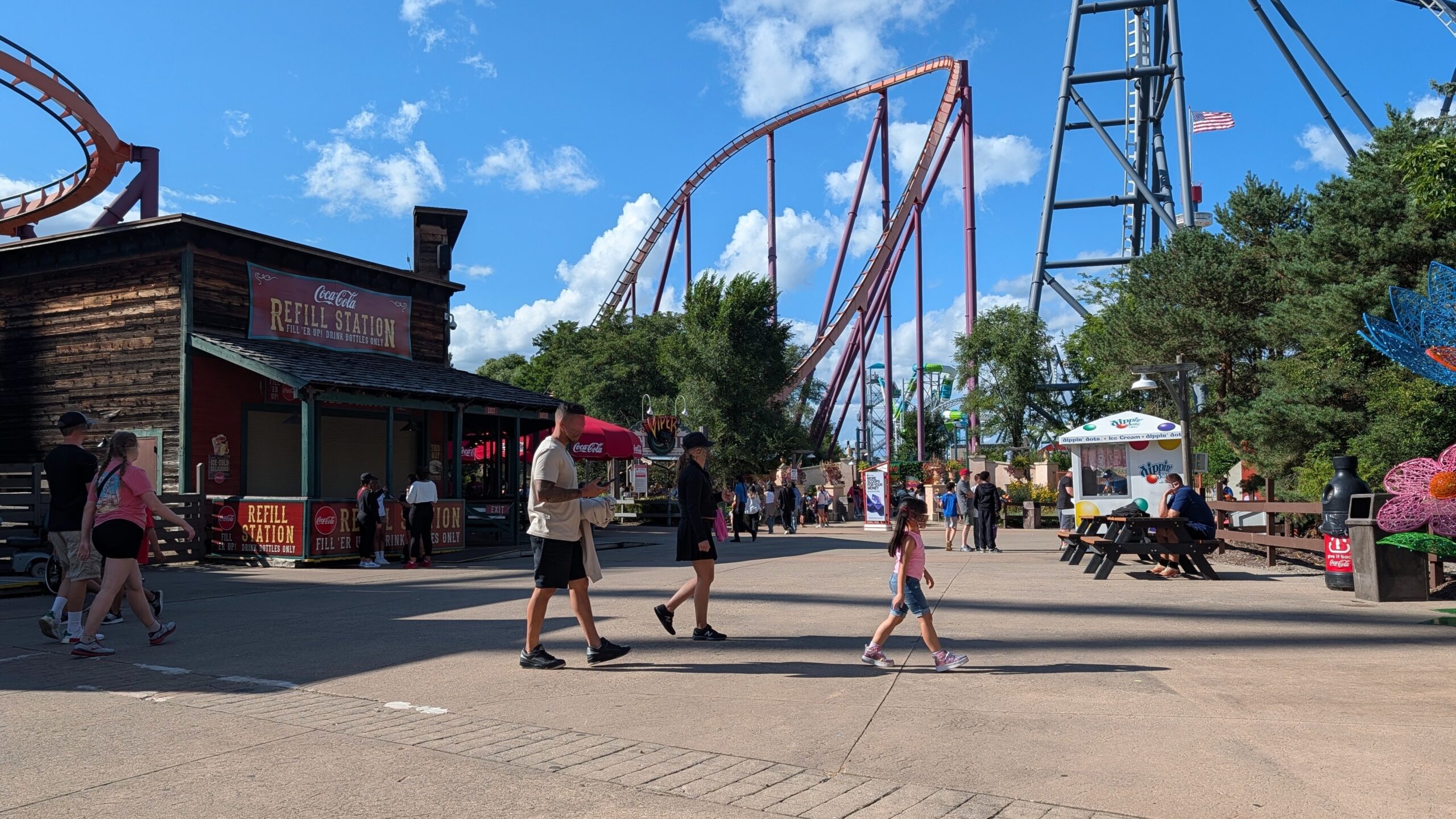 amusement park with people and roller coasters