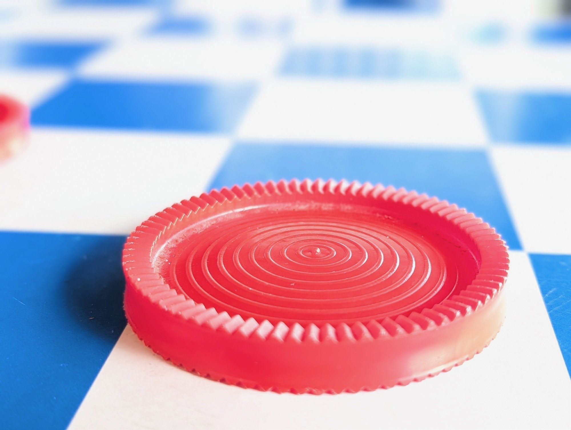 close-up of red checker on checkerboard