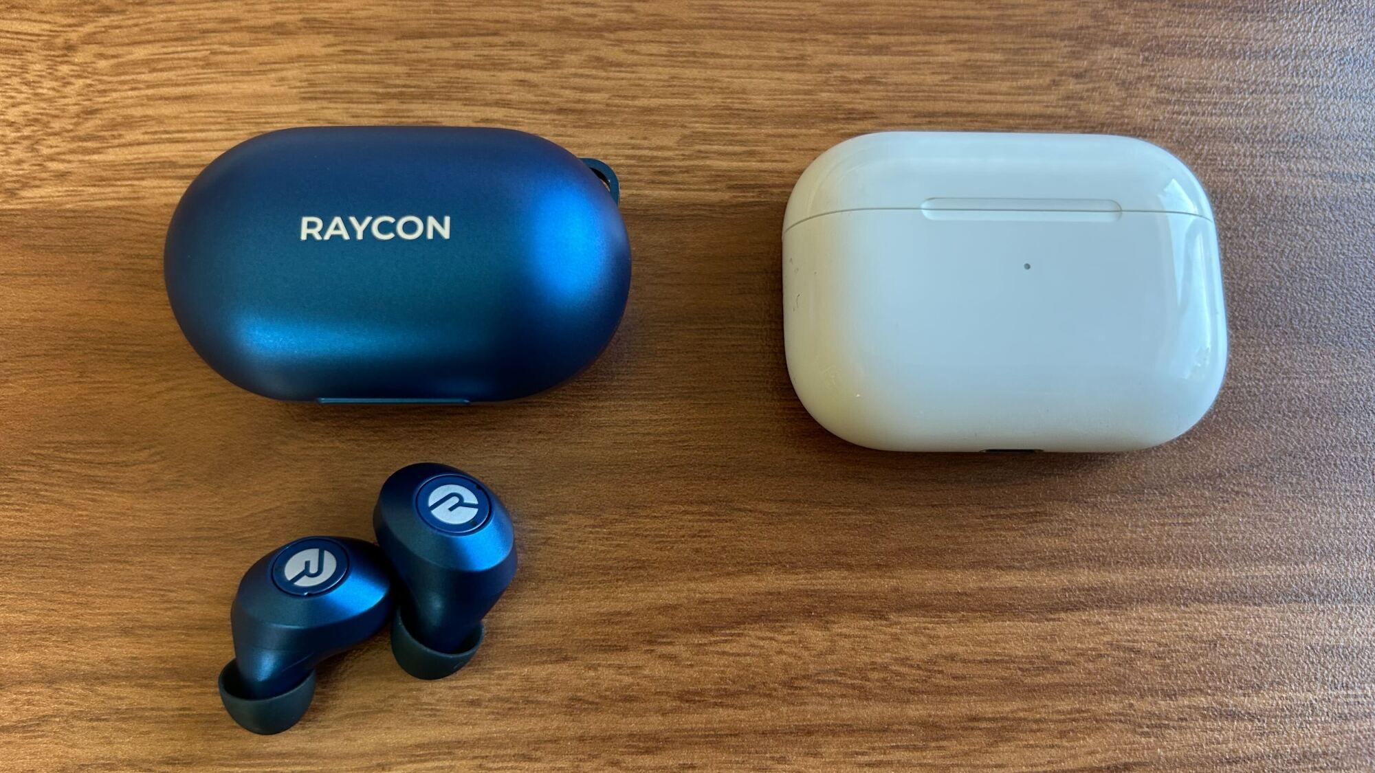 raycon earbuds case and earbuds next to airpods pro gen 1 case