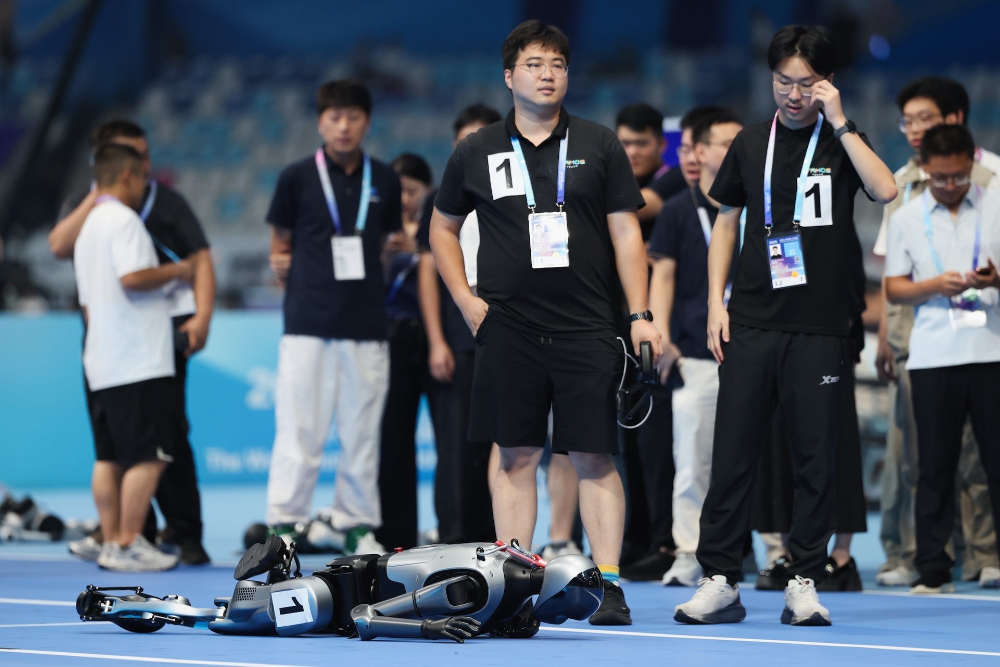 A robot lies on the track at the 2025 World Humanoid Robot Games.