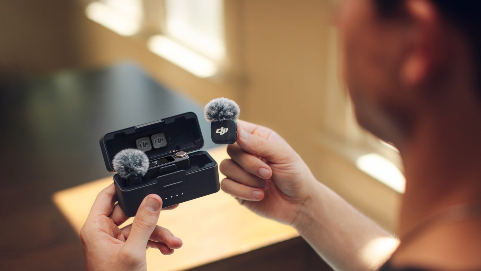 man holding dji mic 3 charging case