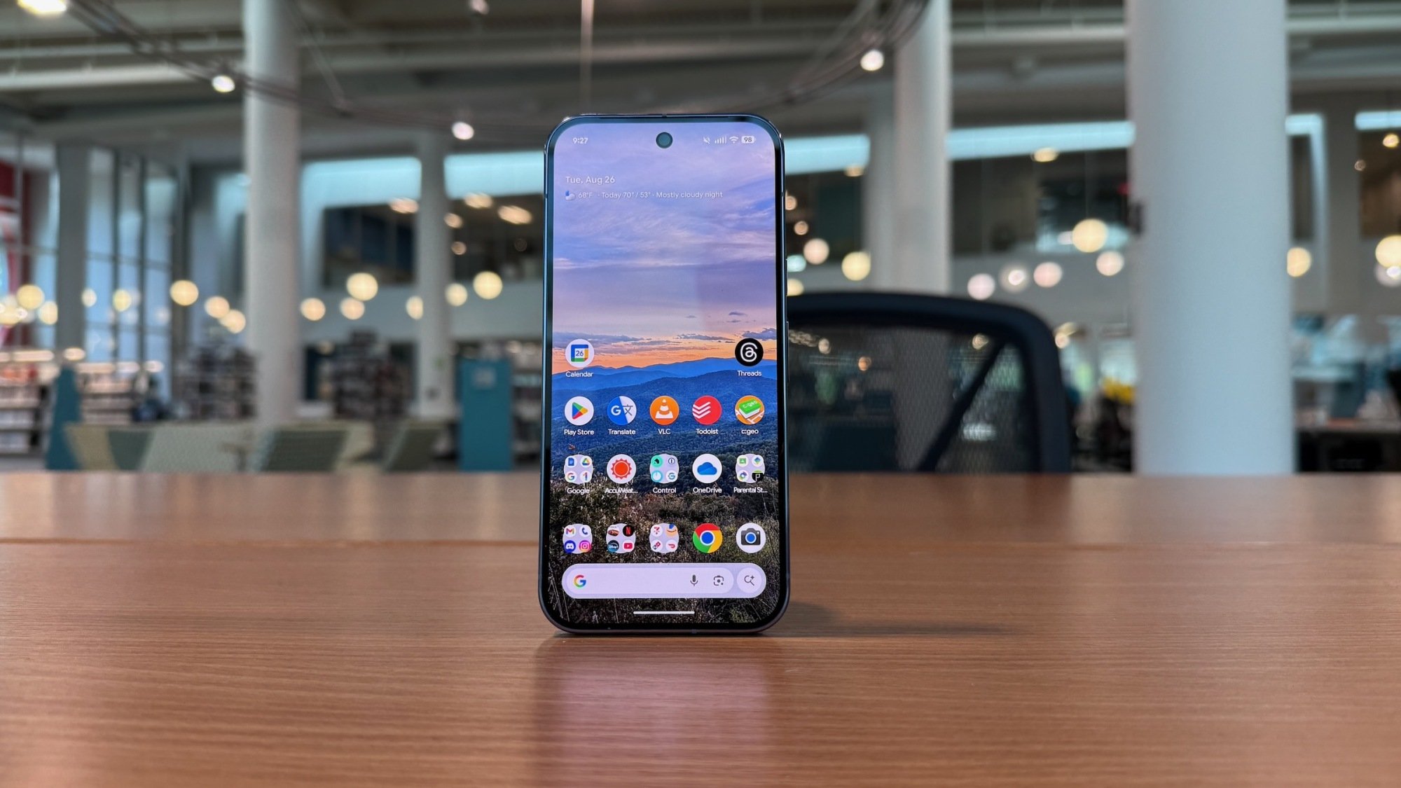 pixel 10 pro stands on desk showing home screen with oled display