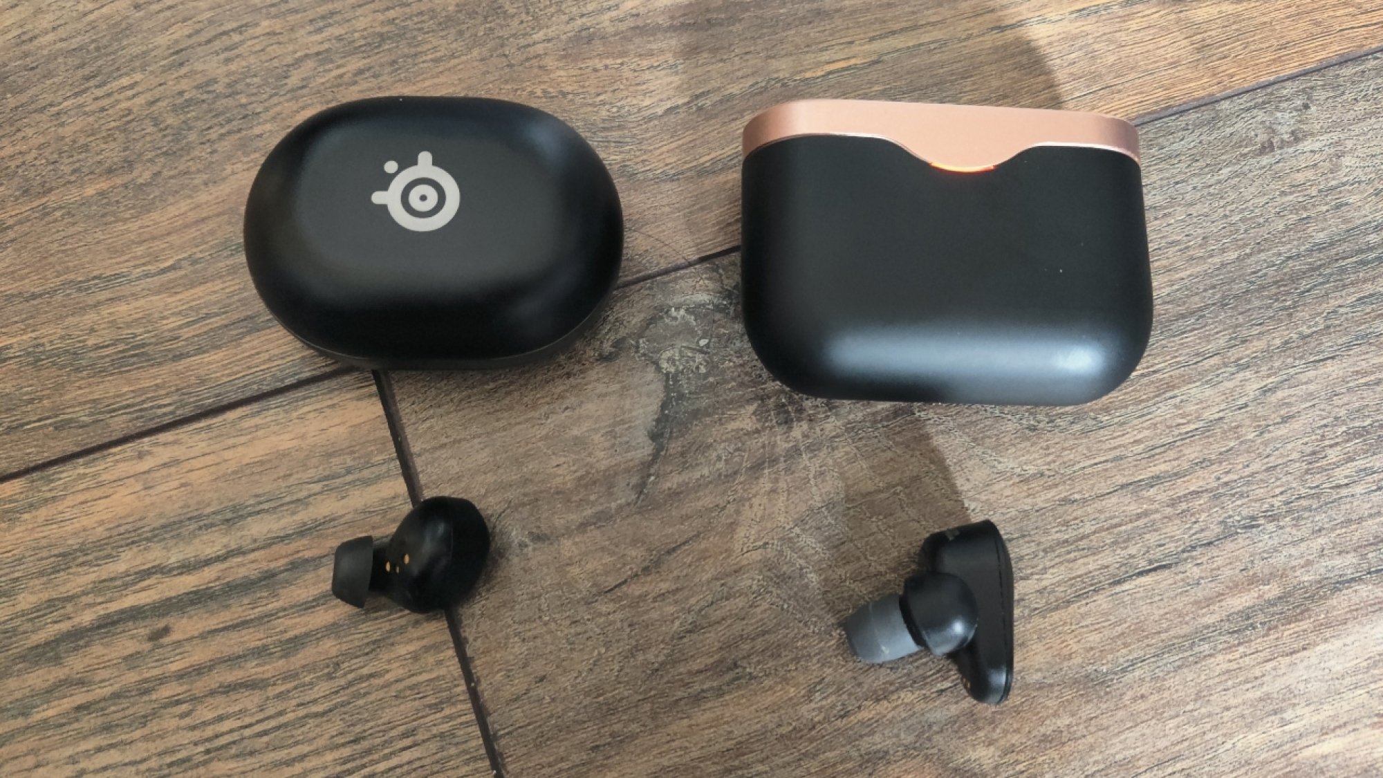 The SteelSeries Arctis GameBuds X next to the Sony WF-1000XM3