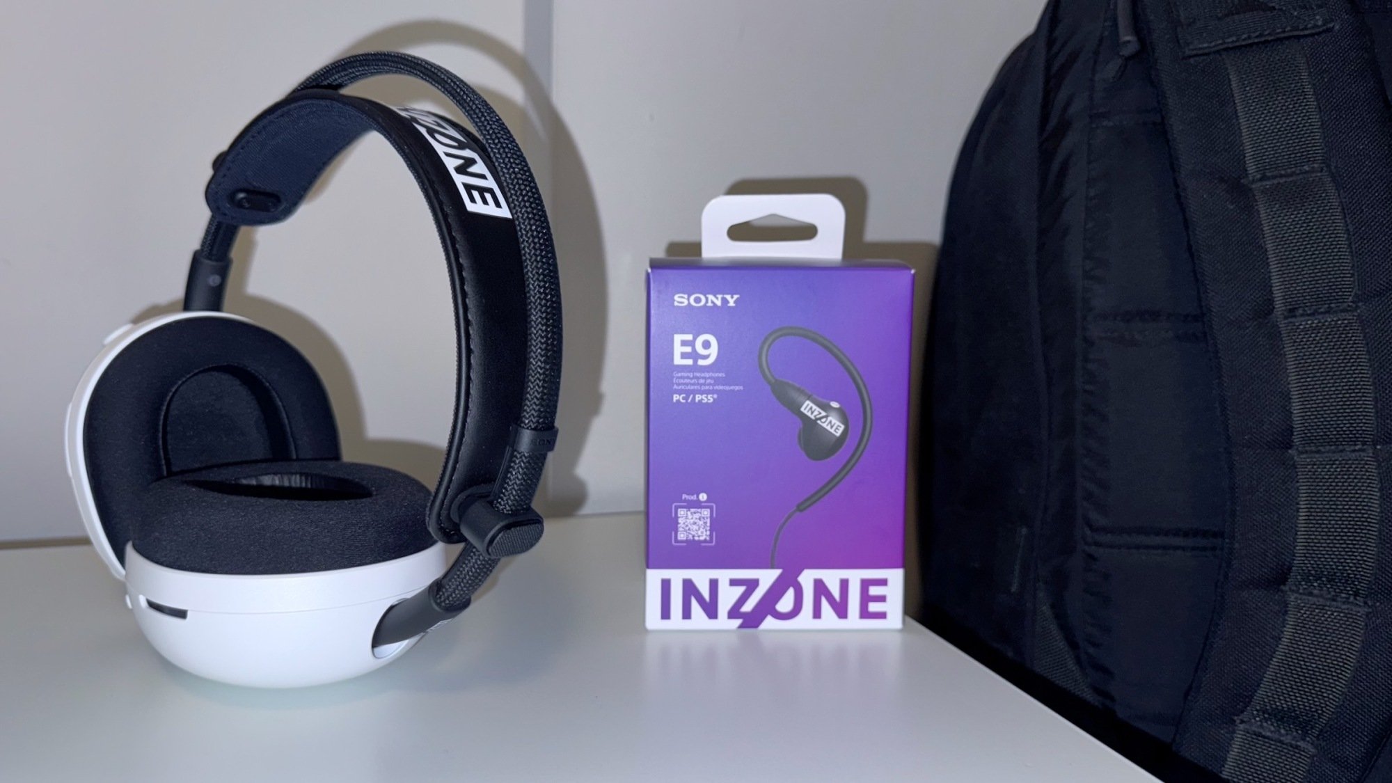 new sony inzone gaming headset and earbuds next to black backpack