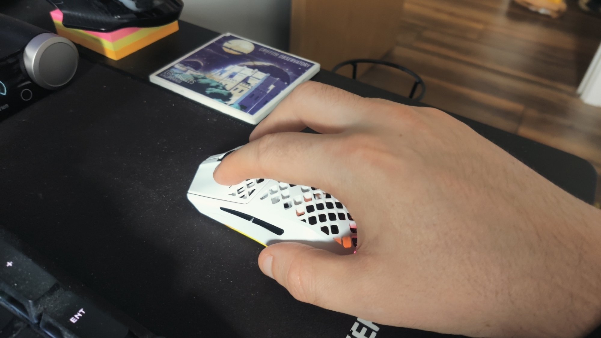 Holding the SteelSeries Aerox 3 Wireless gaming mouse with a flaw grip