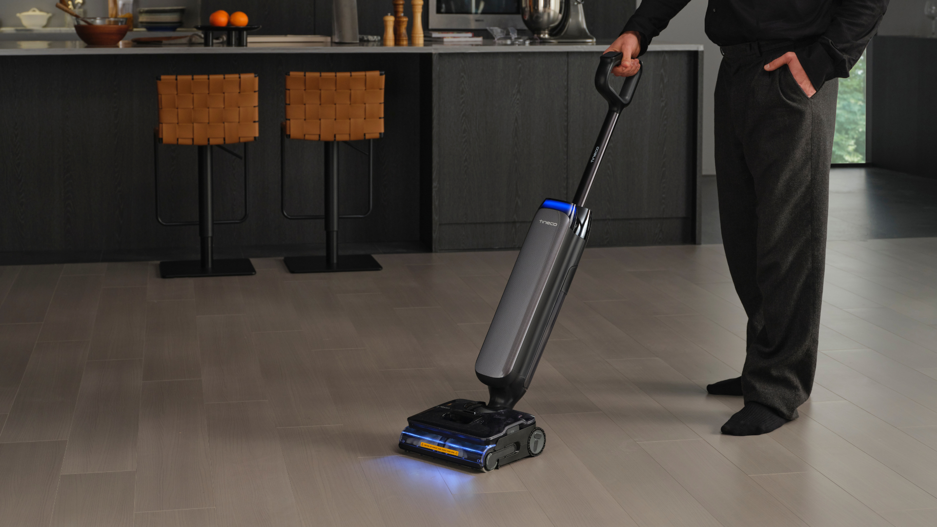 A promotional image of the Tineco S9 Artist Steam being used to clean a kitchen floor.