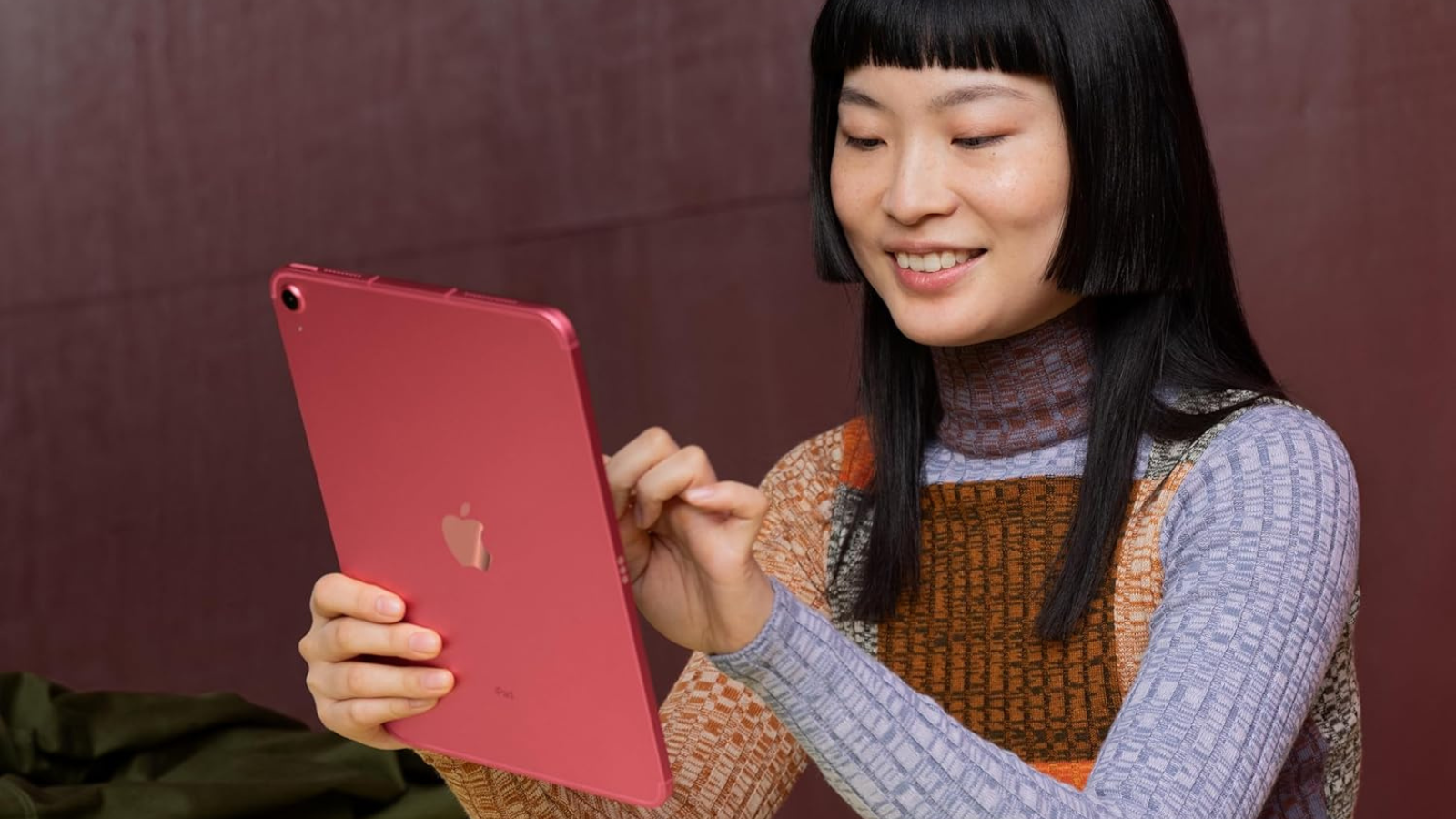 woman using pink Apple iPad 10th generation